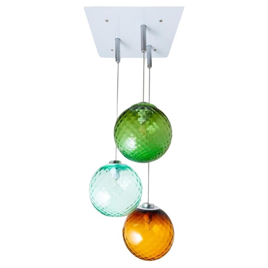 3 lights ceiling chandelier with colored transparent Murano glass spheres For Sale