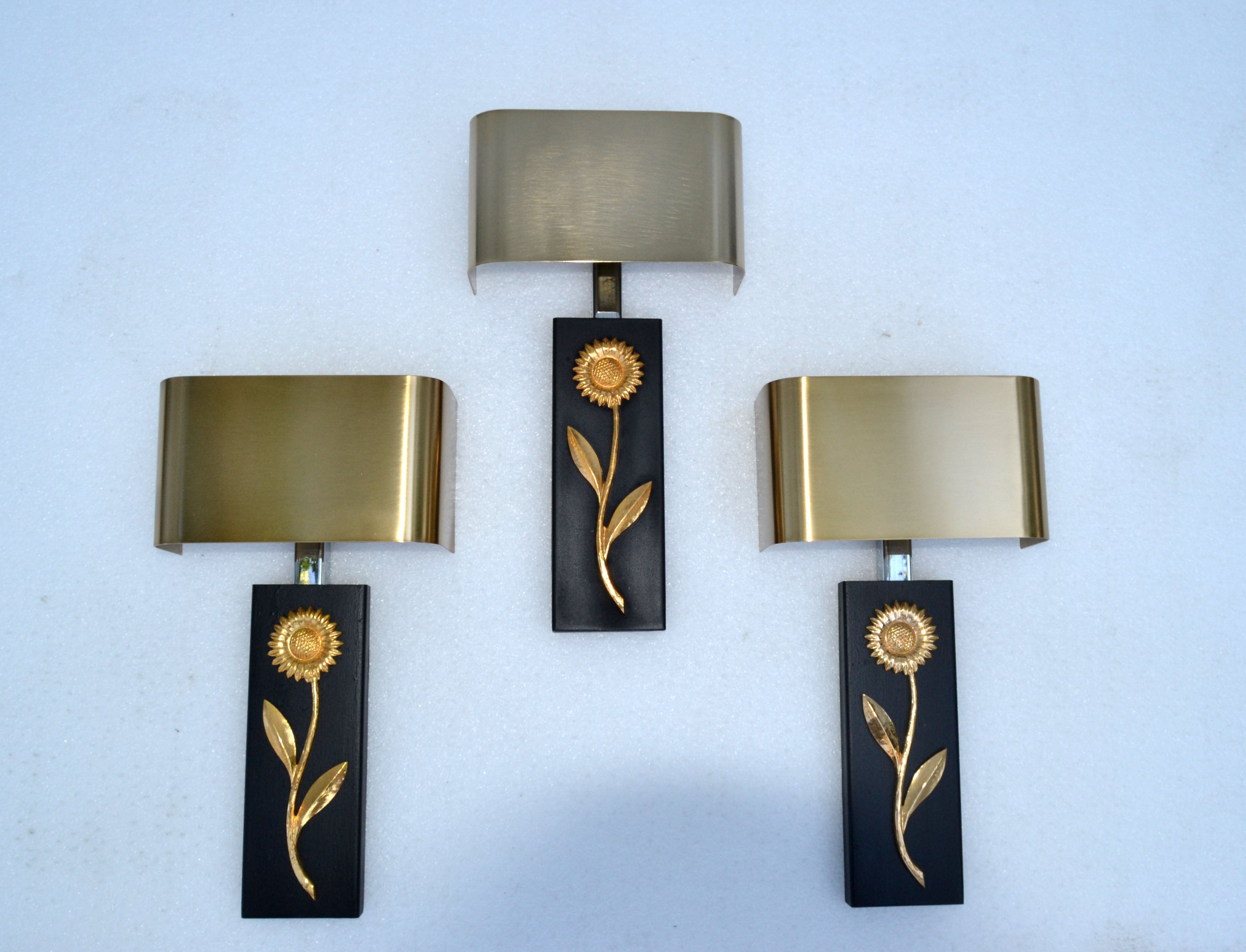 Superb set of 3 wall sconces with bronze flower decor on black frame topped with a brushed brass rectangular shade in the style of Maison Charles.
French Mid-Century Modern and designed in 1970.
US rewiring and each Sconce takes 2 candelabra light