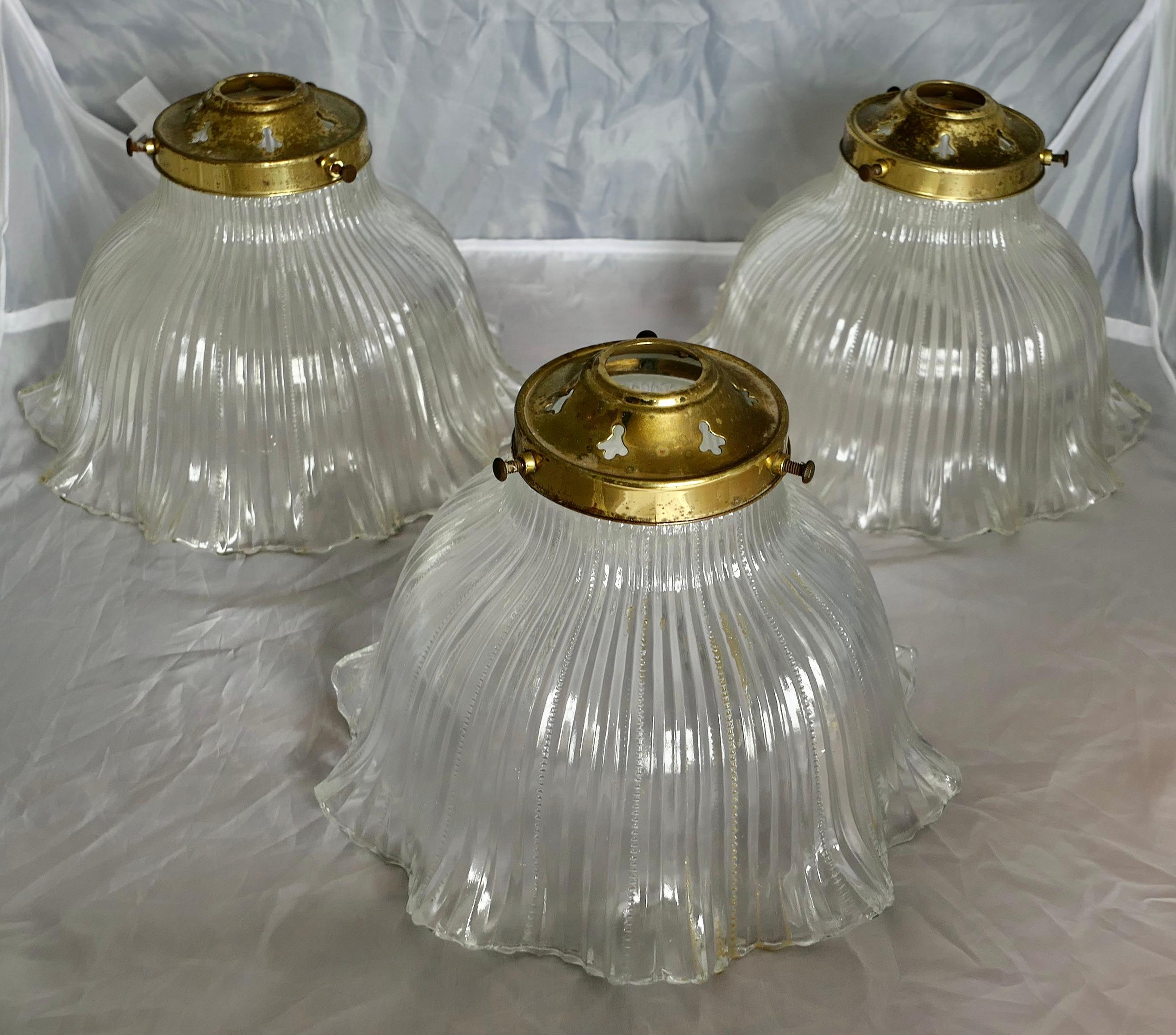 3 Matching Antique Holophane Lamp Shades

This fabulous set of frilly holophane glass ceiling Lamp Shades
are in excellent and original condition with brass galleries and ready to be hung
The lights are 7” high and 9” in diameter 
SW28