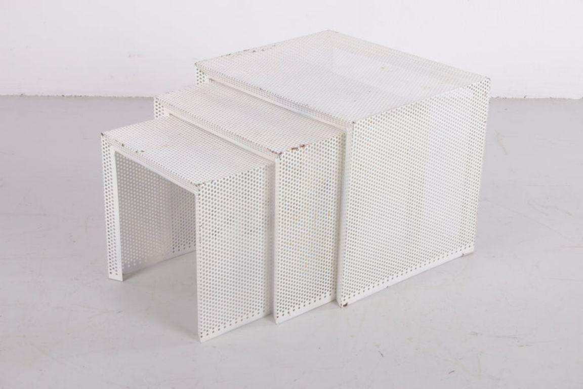 Mathieu Matégot Metal Nesting Tables in White

A set of three nice decorative nesting tables from the Hungarian designer Mathieu Matégot.
This designer was known for his pioneering material and technique, Rigitulle, in which he combined perforated