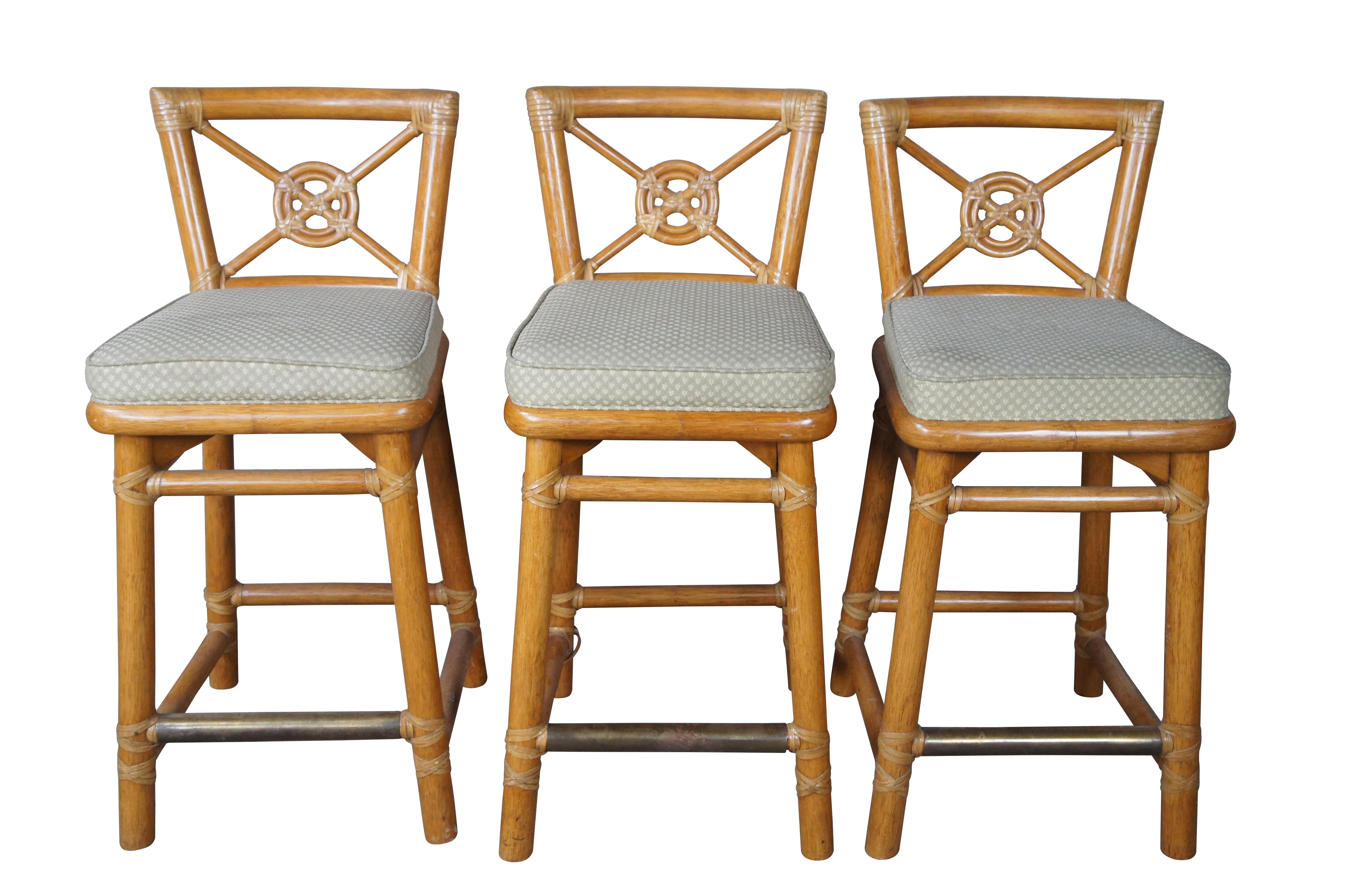 Set of Iconic target back bar stools by The McGuire Furniture Company.  Organic Modern with Bohemian design.  Features a faux bamboo and rattan construction with fabric seats.  the stools have strong legs with solid joinery and brass foot rests. 