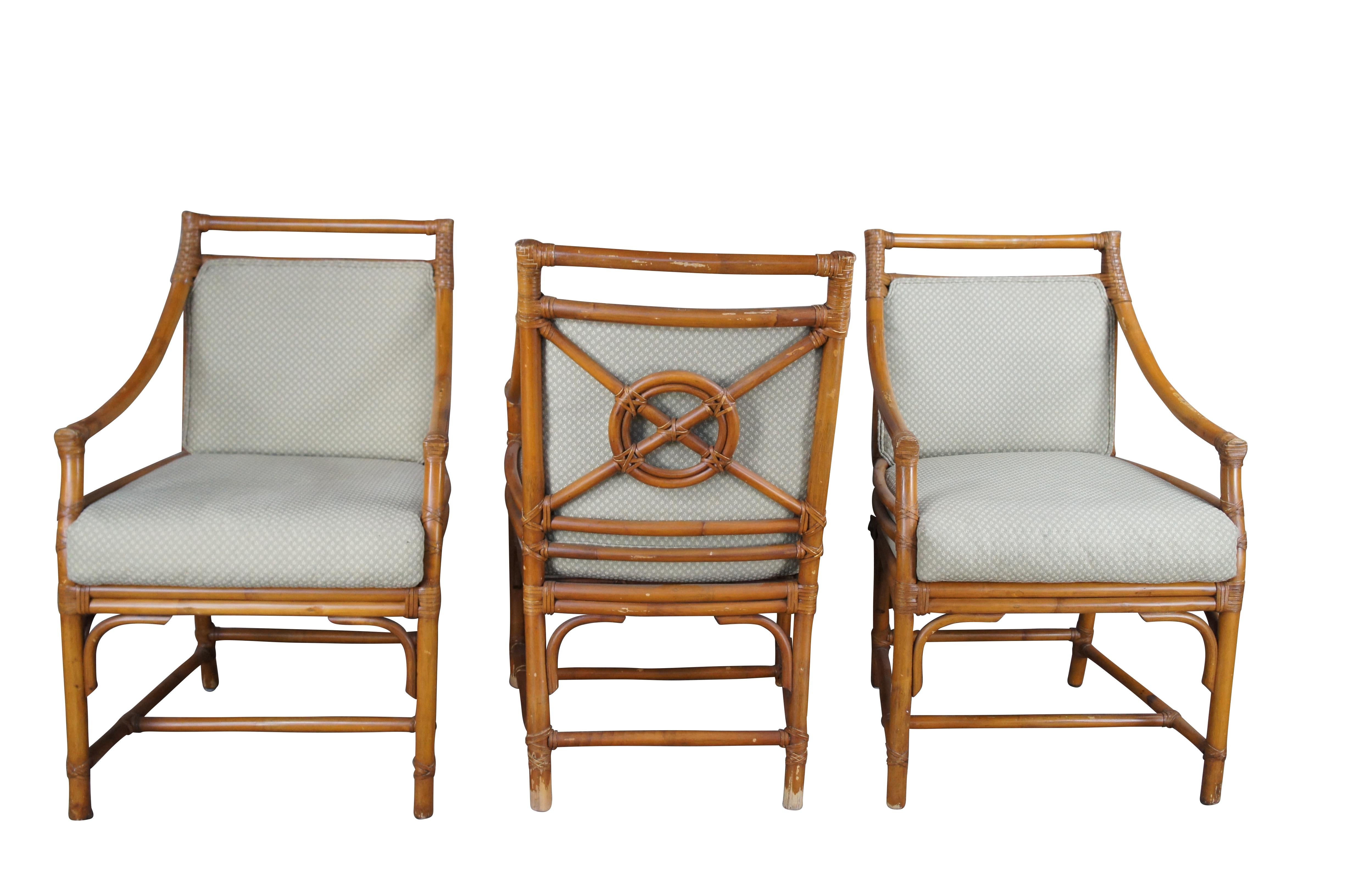 Set of Iconic target back Arm Chairs by The McGuire Furniture Company. Organic Modern with Bohemian design. Features a faux bamboo and rattan construction with fabric seats. Seats are green with foliate design. 

John and Elinor McGuire founded