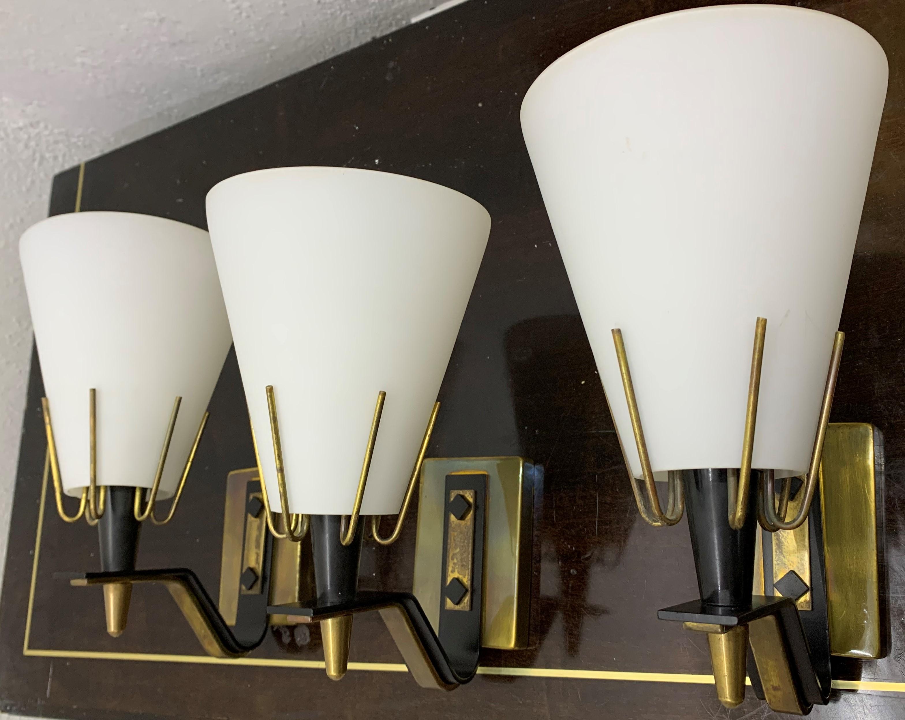One left at the moment 
Mid-Century Modern sconce attributed to Stilnovo, Italy, circa 1950
Materials:
Opaline glass
Brass
Lacquered metal

Priced individually.