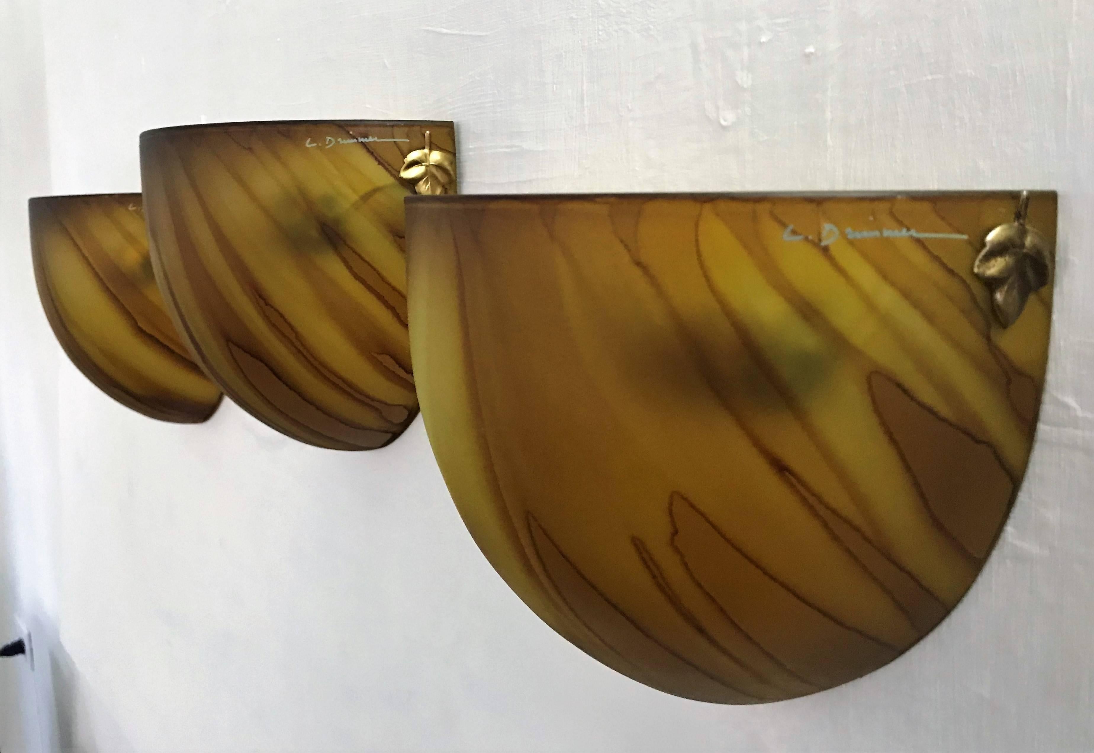 Beautiful set of three Mid-Century Modern glass sconces made in France, circa 1970 by the interior decorator Louis Drimmer, signed at the glass and still retaining the original label.
