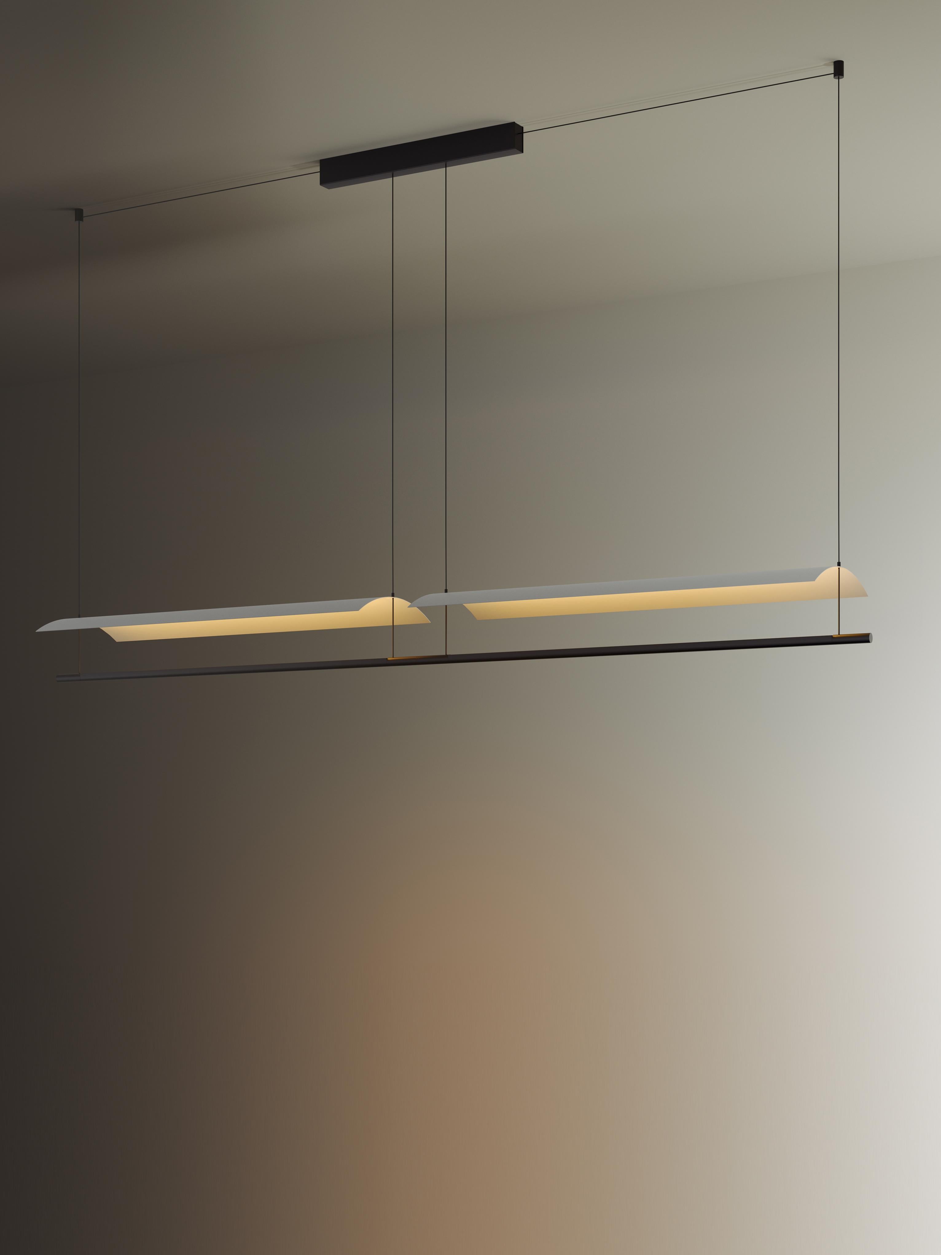 Sistema Lámina 85 pendant lamp by Antoni Arola
Dimensions: D 3.5 x W 297.1 x H 300 cm
Materials: Metal, plastic.
3 modules.

A line of light and a thin metal sheet create a soft but effective levity. A marriage of the poetic and the practical,