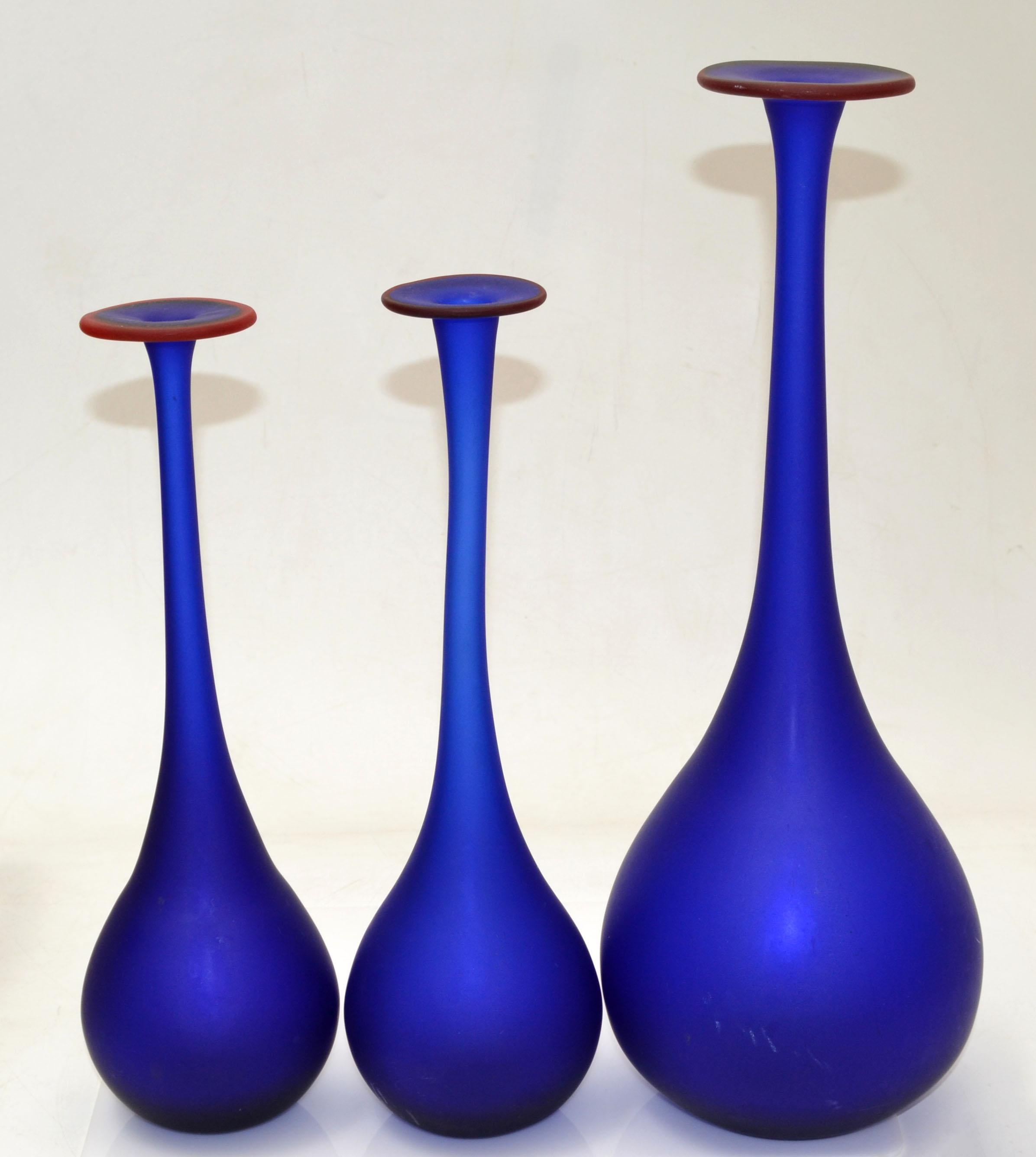 Set of 3 Carlo Moretti Style Mid-Century Modern satin glass bud vases in translucent blue with a red opening.
Nesting set, the smaller ones are 3.5 inches in diameter, height 11.5 & 12 inches.
Very beautiful and clean design.

