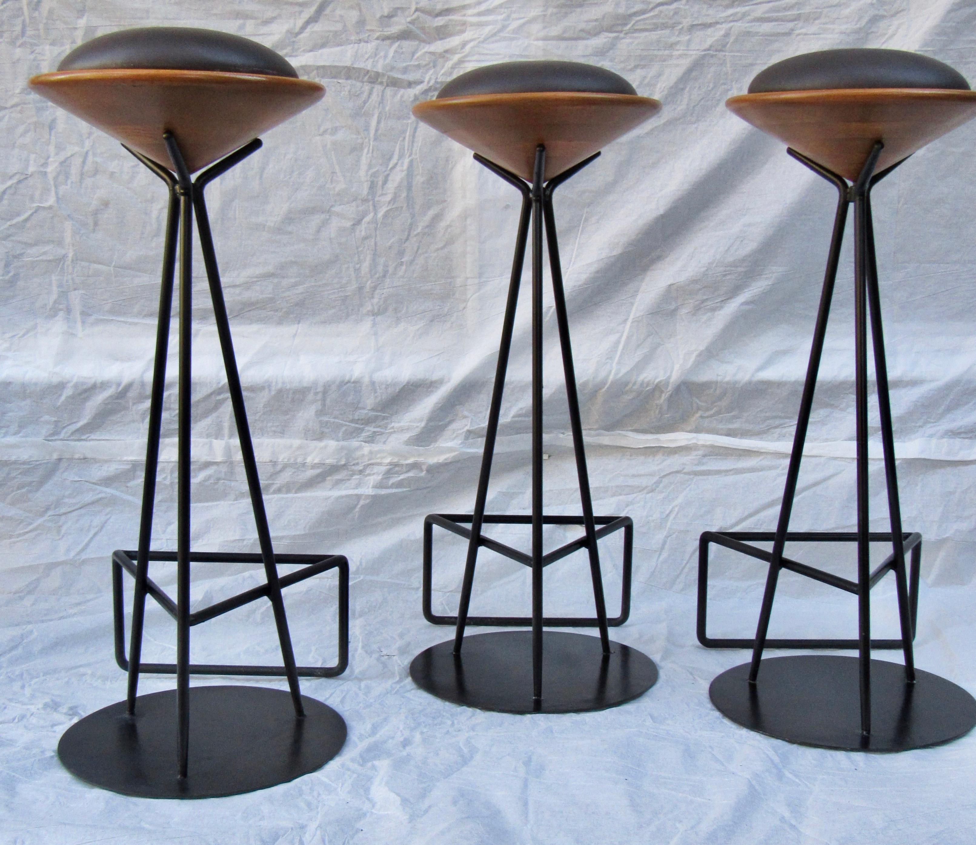 Three wrought iron bar stools from Palm Springs, circa 1960s. 
The seat supports are laminated oak that are lathe turned which hold the seat cushion.
The bar stools are in excellent condition.