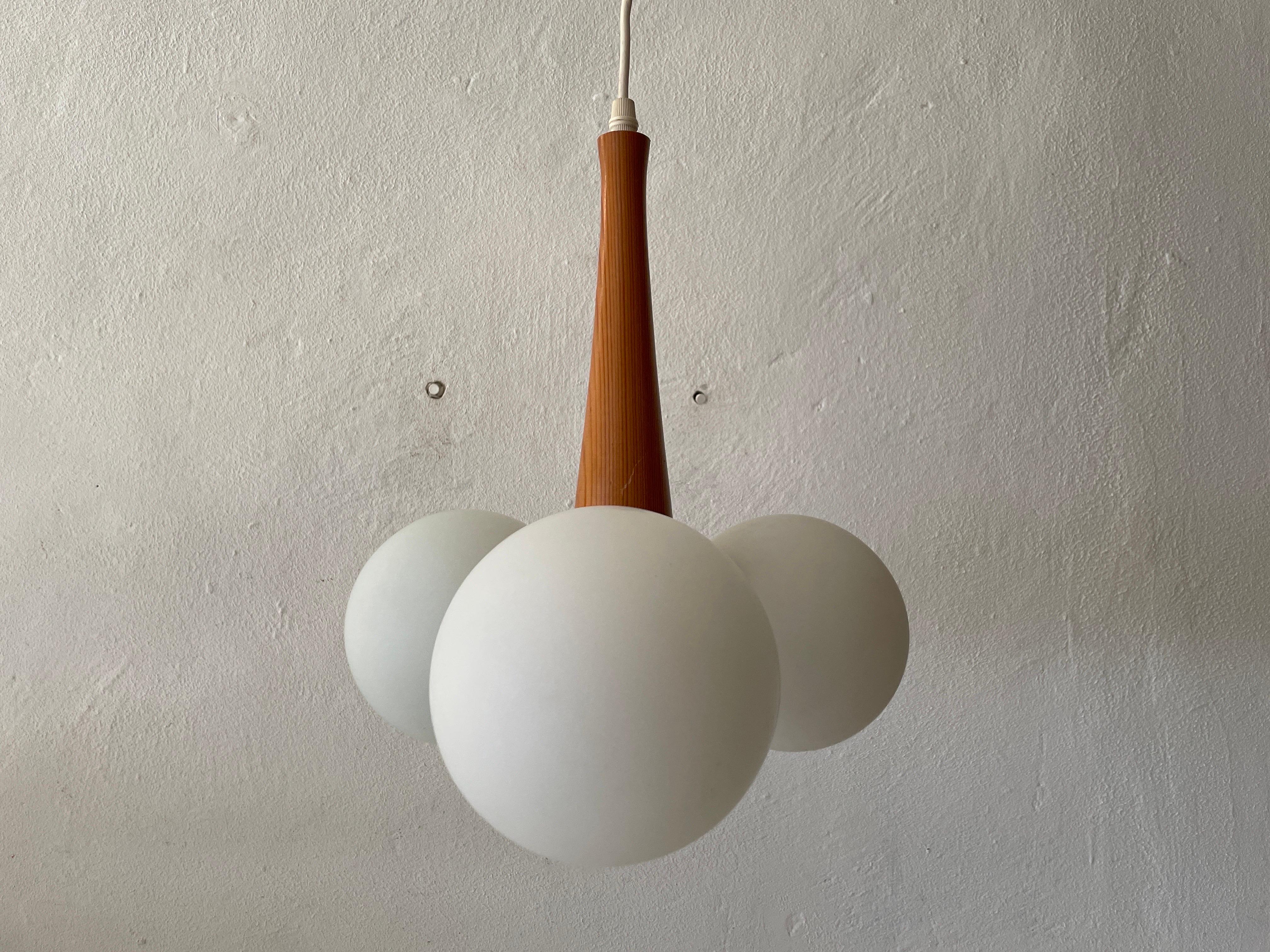 3 Opal Ball Glass and Wood Body Atomic Ceiling Lamp, 1970s, Germany

Lampshade is in good condition and very clean. 
This lamp works with 3 x E14 light bulb. 
Wired and suitable to use with 220V and 110V for all