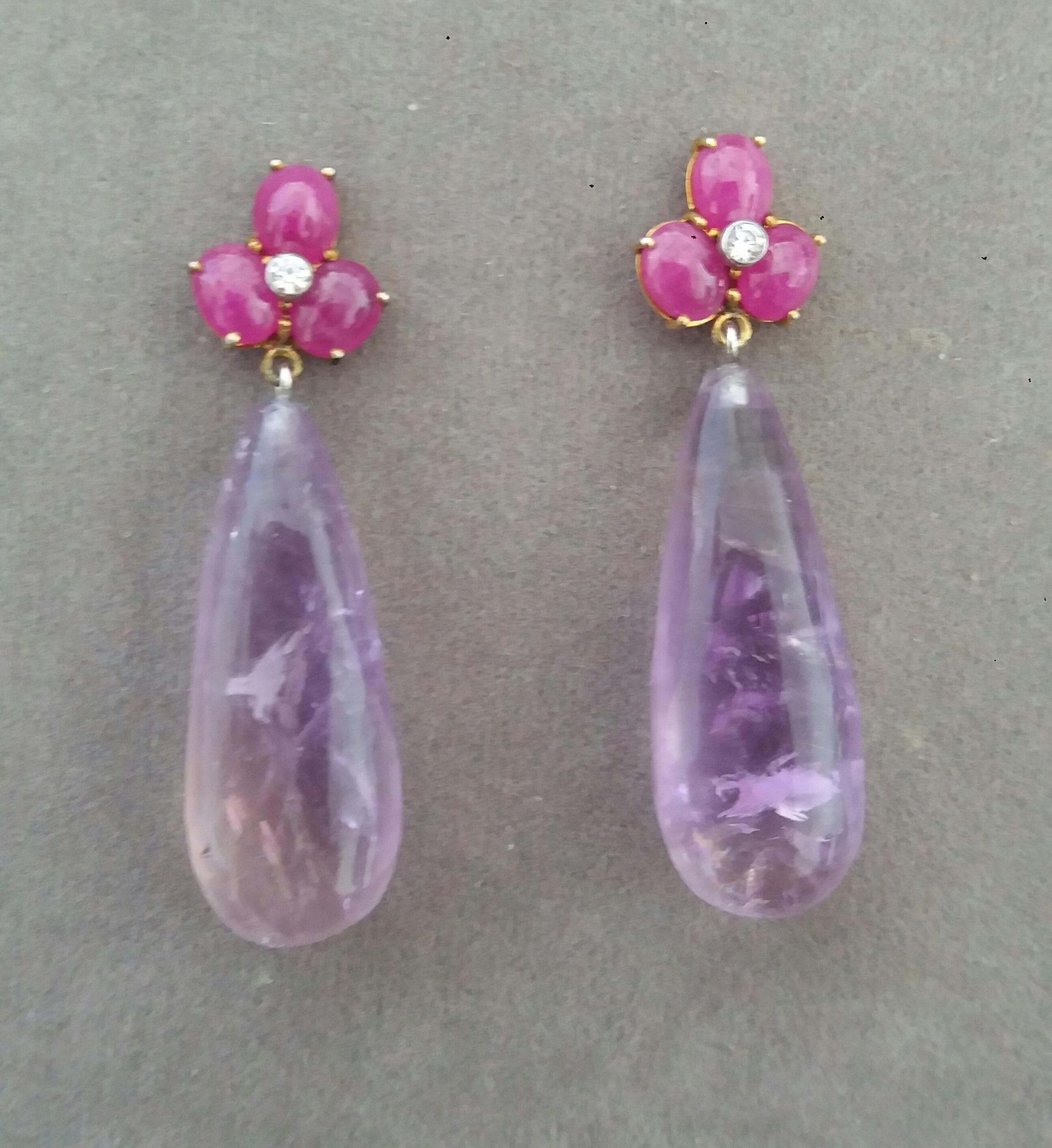 Simple elegant and completely handmade Earrings consisting of an upper part of 3 oval shape Ruby cabs of 4 mm x 5 mm set together in 14 Kt yellow gold with 2 small diamonds in the center, at the bottom 2 Round Drop Amethyst measuring 12 mm x 30