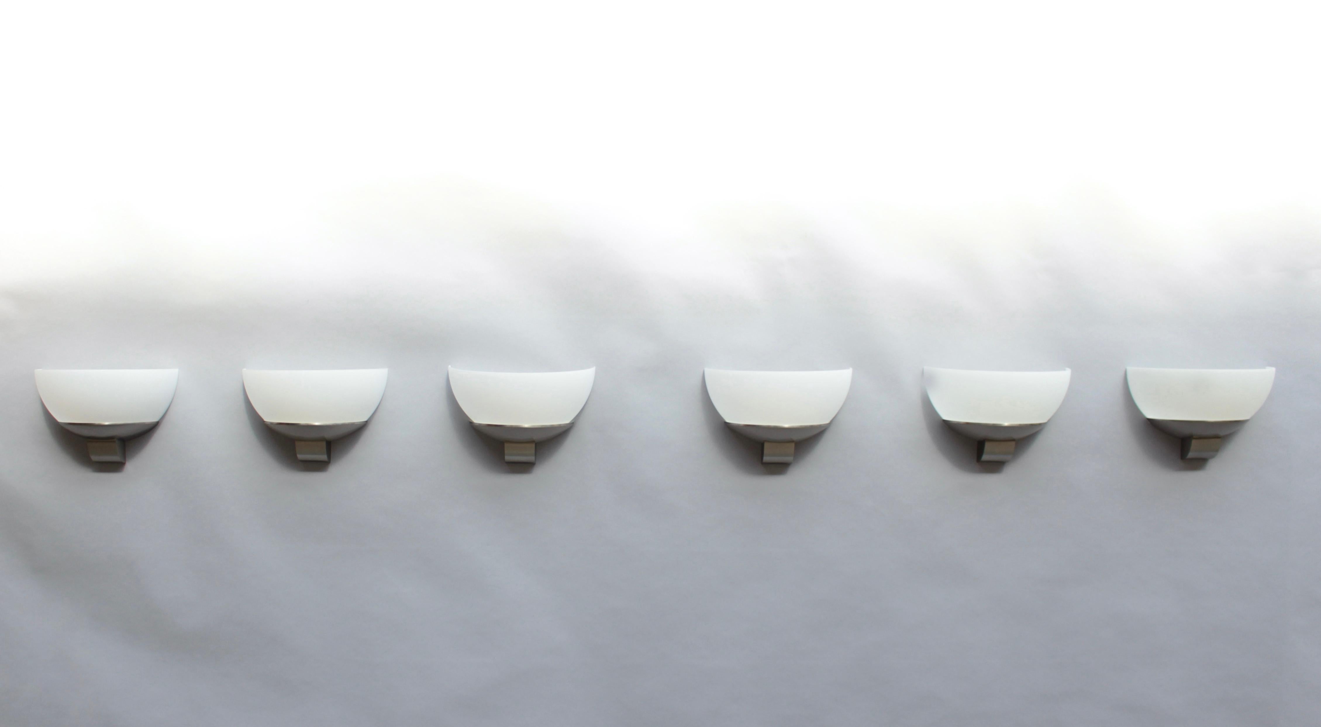 Atelier Jean Perzel - Three pairs of fine French Art Deco wall lights with a white enameled glass shade mounted on a brushed nickel frame.
This model trimmed the walls of 