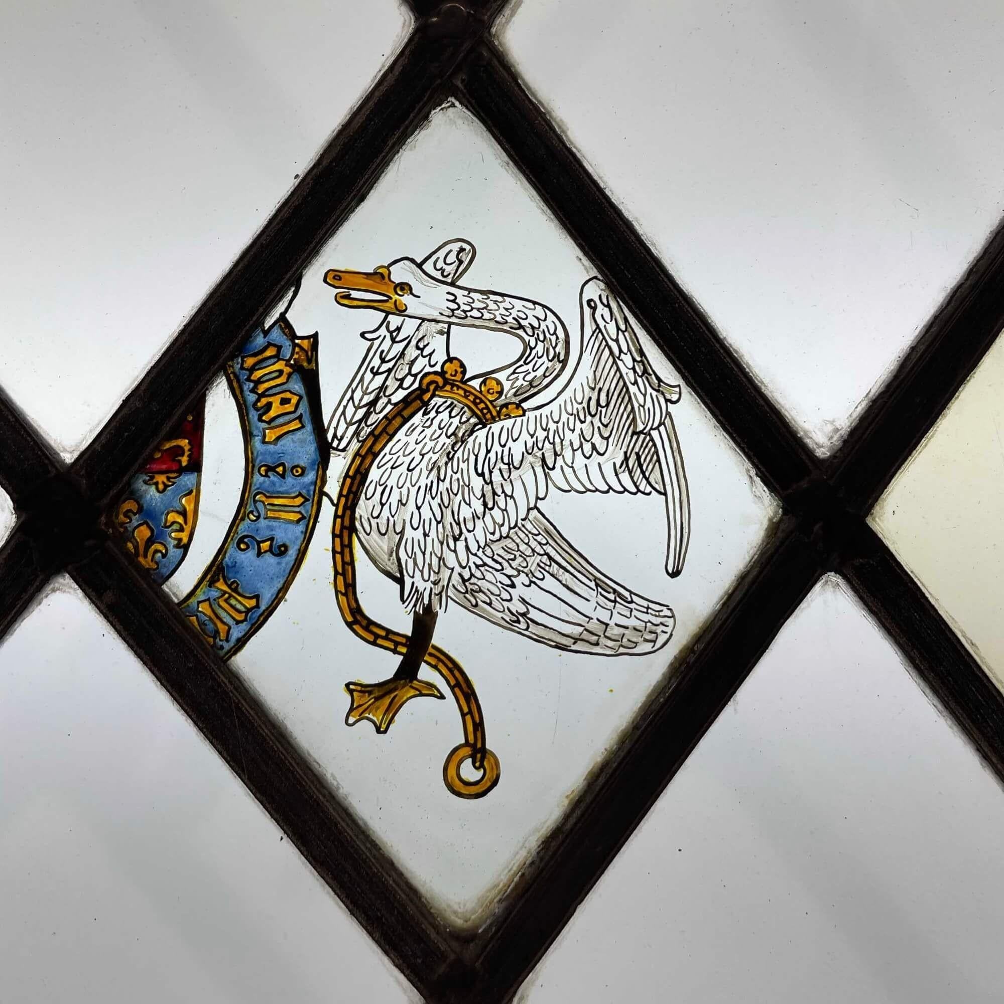 A 3 pane antique stained glass window detailed with hand painted heraldic symbols: a Bohun swan, rampant lions and a mythical creature with the tail of a lion, body of a leopard, horns of a gazelle and head of a boar.

Dating from the mid 19th