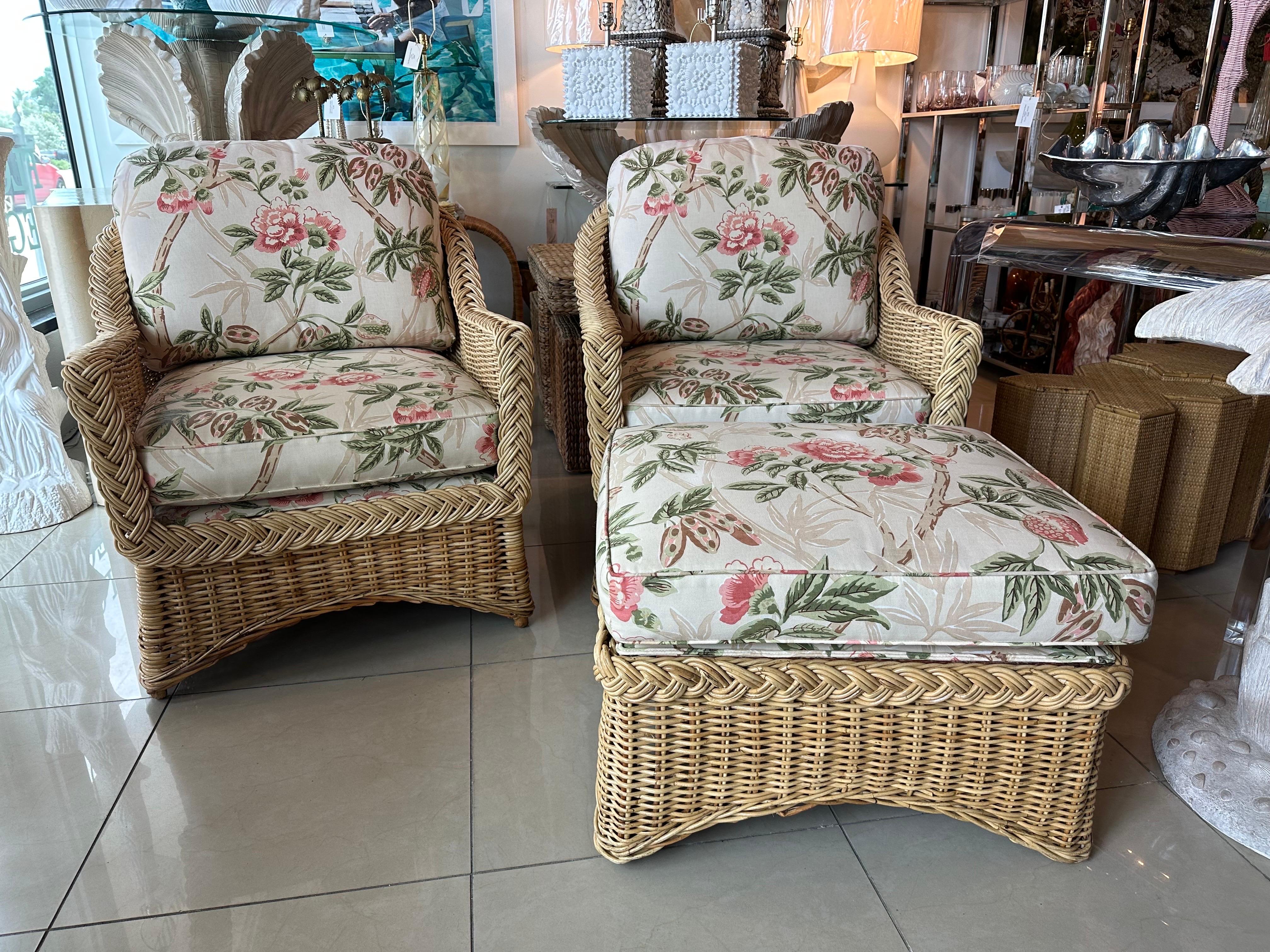 Lovely 3 piece set. Pair of braided wicker rattan lounge club arm chairs and one ottoman. By Wicker Works. No damage to the wicker/rattan. Recently recovered, as found upholstery. Both cushions have zippers. No stains or damage seen but may have