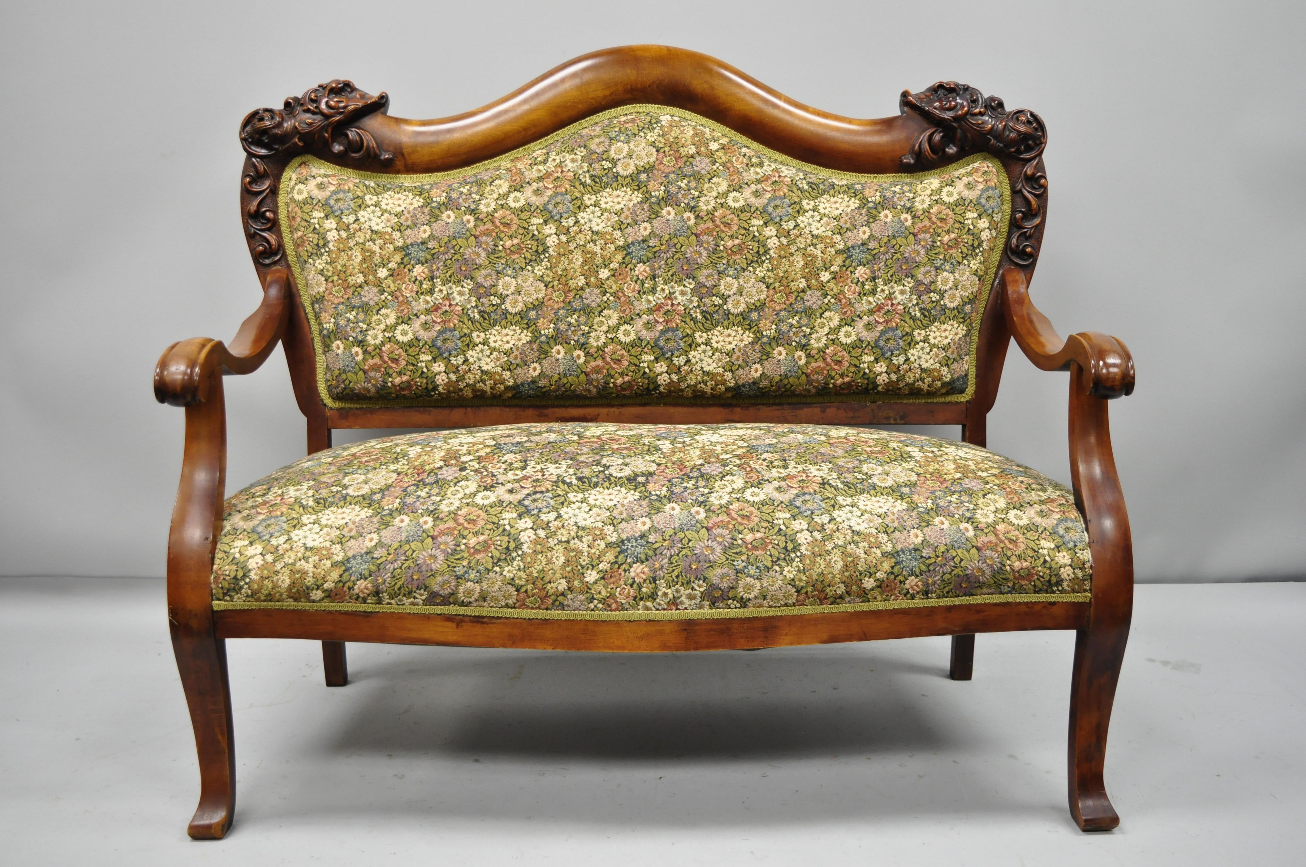 3 piece Victorian Empire mahogany dolphin carved parlor set. Set includes, loveseat, armchair, side chair, open mouth gesso dolphins, floral fabric, beautiful wood grain, and great style and form, circa late 19th century. Measurements: Sofa 41.5