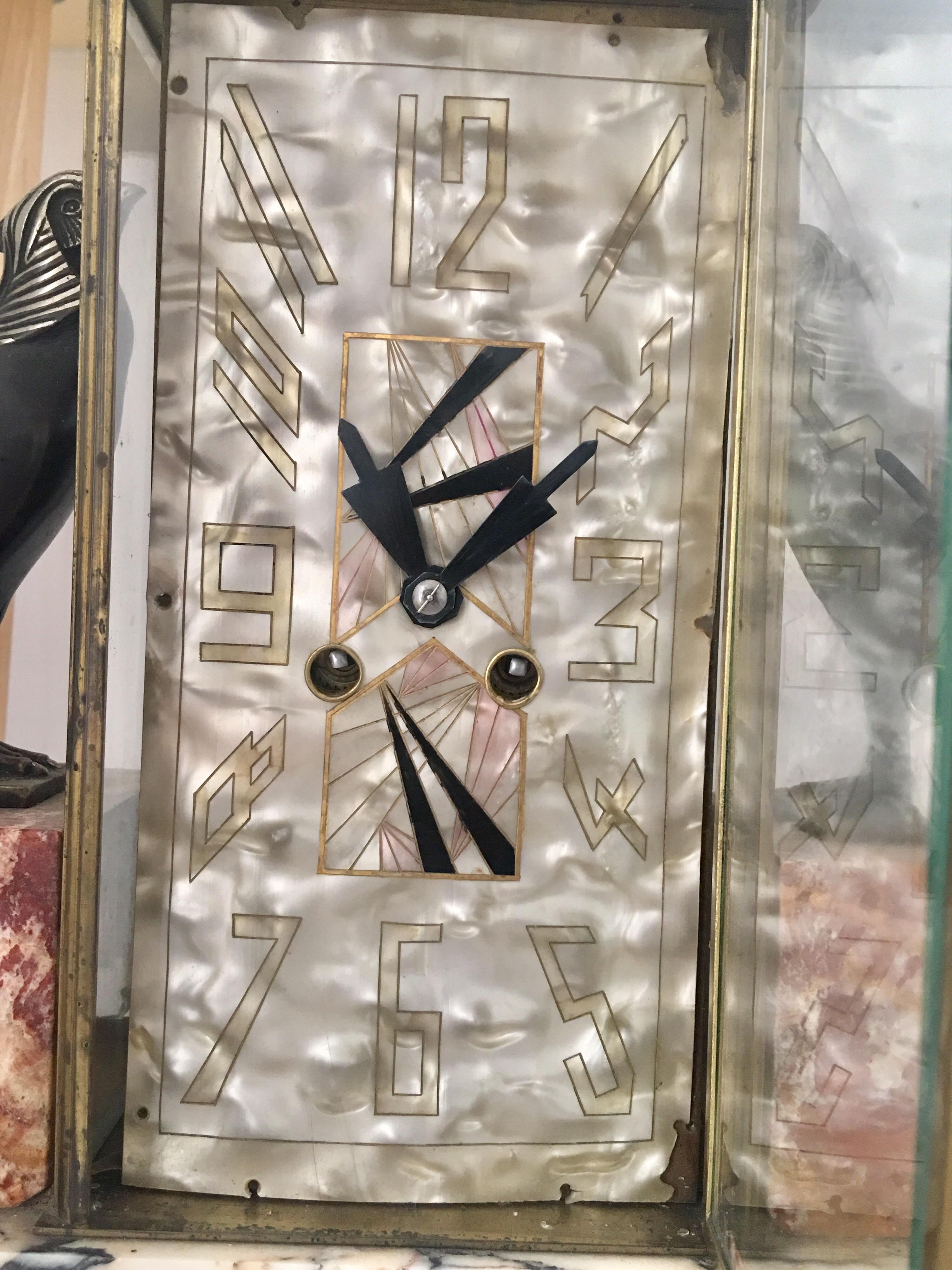 This stunning 3 pieces set Art Deco Italian marble with bronze and silvered peasant four glass Paris clock is working and ticking well. It strikes every hour and half the hour on a bell. Pendulum driven French movement. It has visible chipped on the
