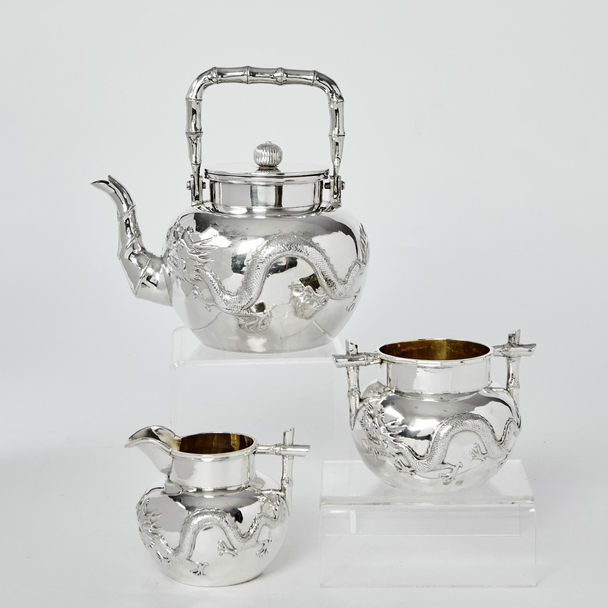 Classic Chinese export silver tea set comprising teapot, milk jug and sugar bowl made in the Liang Sheng ?? workshop. For thousands of years dragons have symbolised wisdom, harmony and prosperity in China and each piece of this charming antique