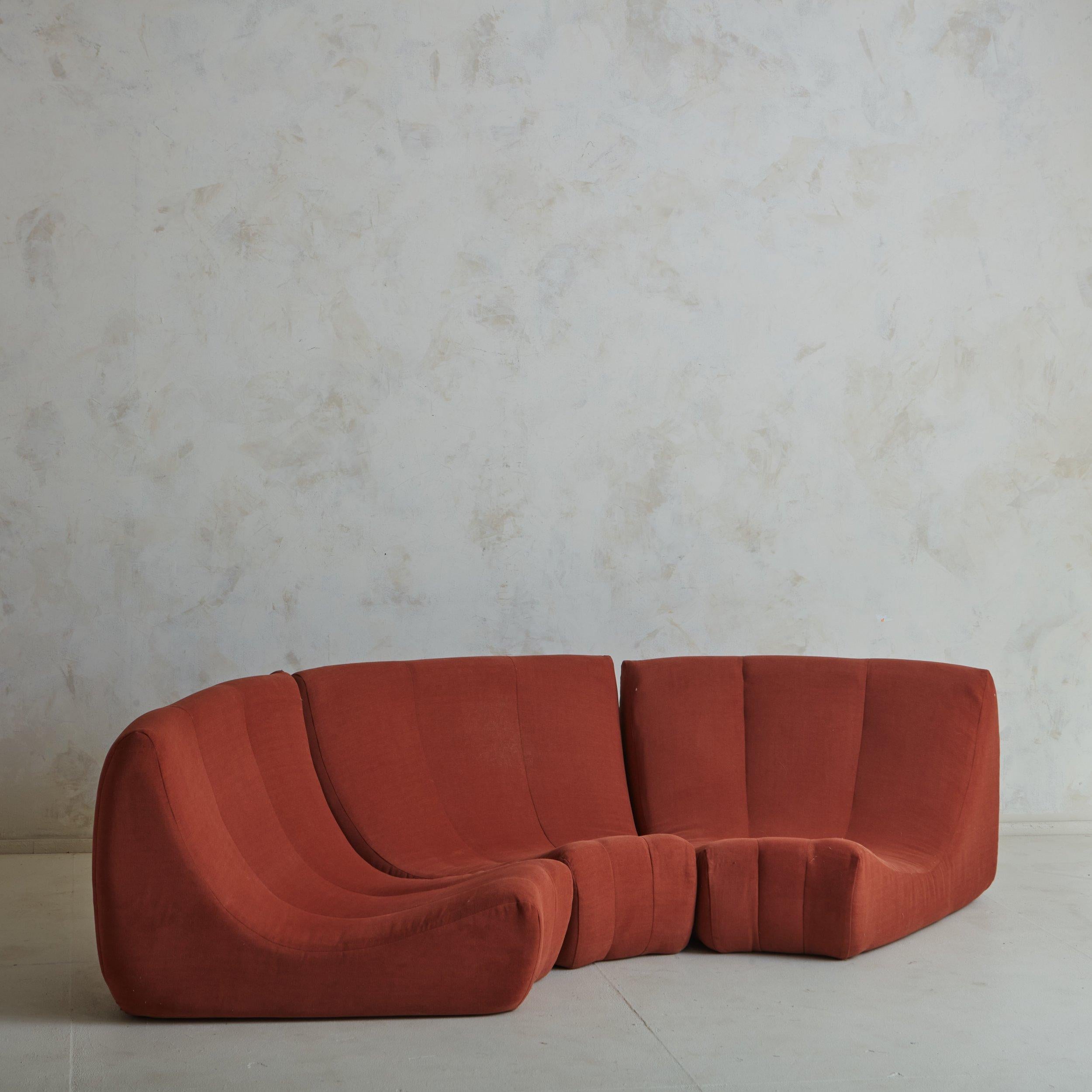 A French ‘Gilda’ sofa designed by Michel Ducaroy for Ligne Roset in 1972. This piece is modular; when the curved units are aligned, it creates a circle. This ‘Gilda’ sofa includes three sections in original coral ref fabric. The sections can stand