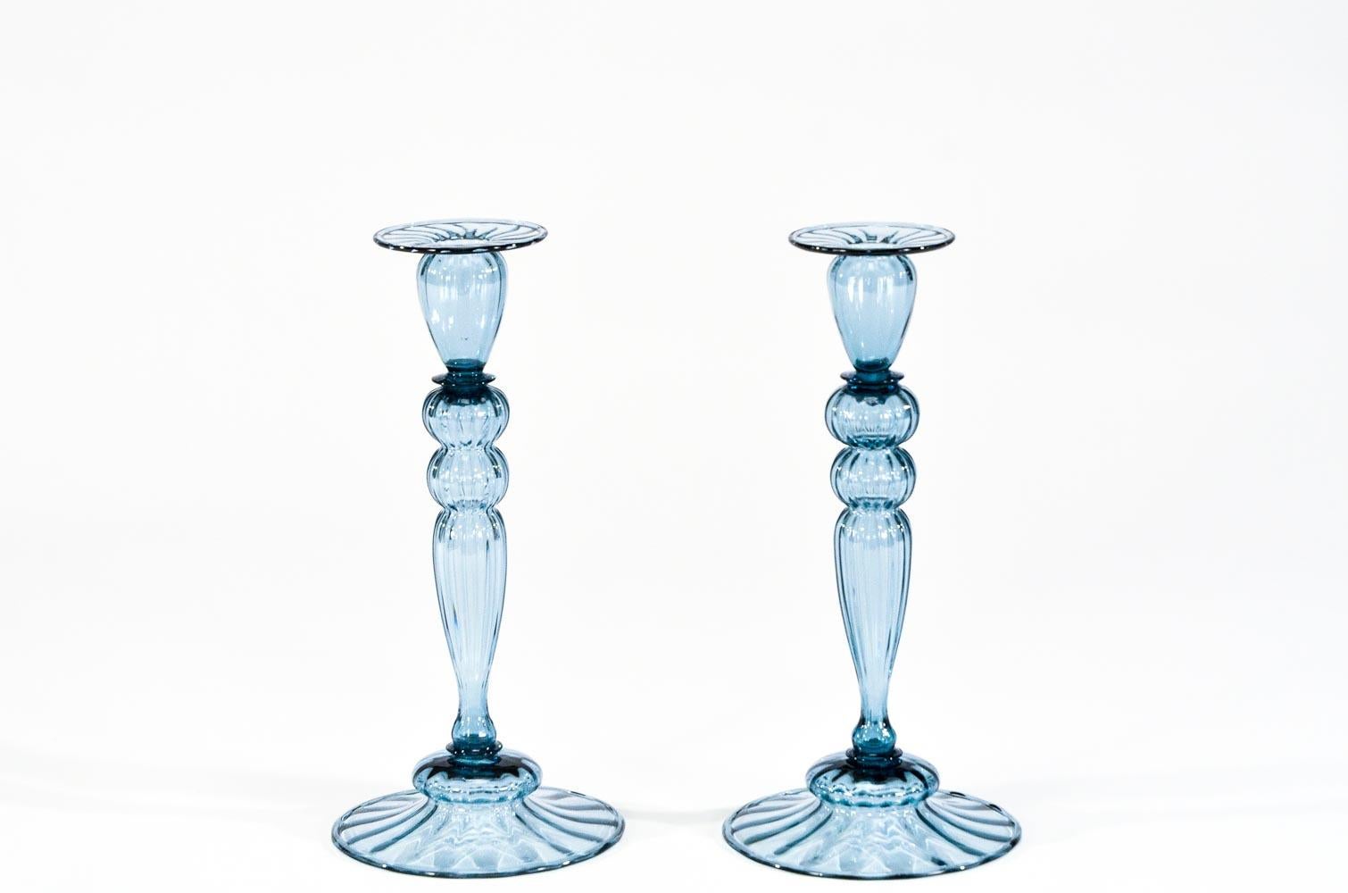 This 3-piece centerpiece set is hand blown in an unusual steel blue color which sets it apart from the more conventional colors. The optic ribbing gives them a more dimensional feel but still maintaining very clean and simple lines. The perfect