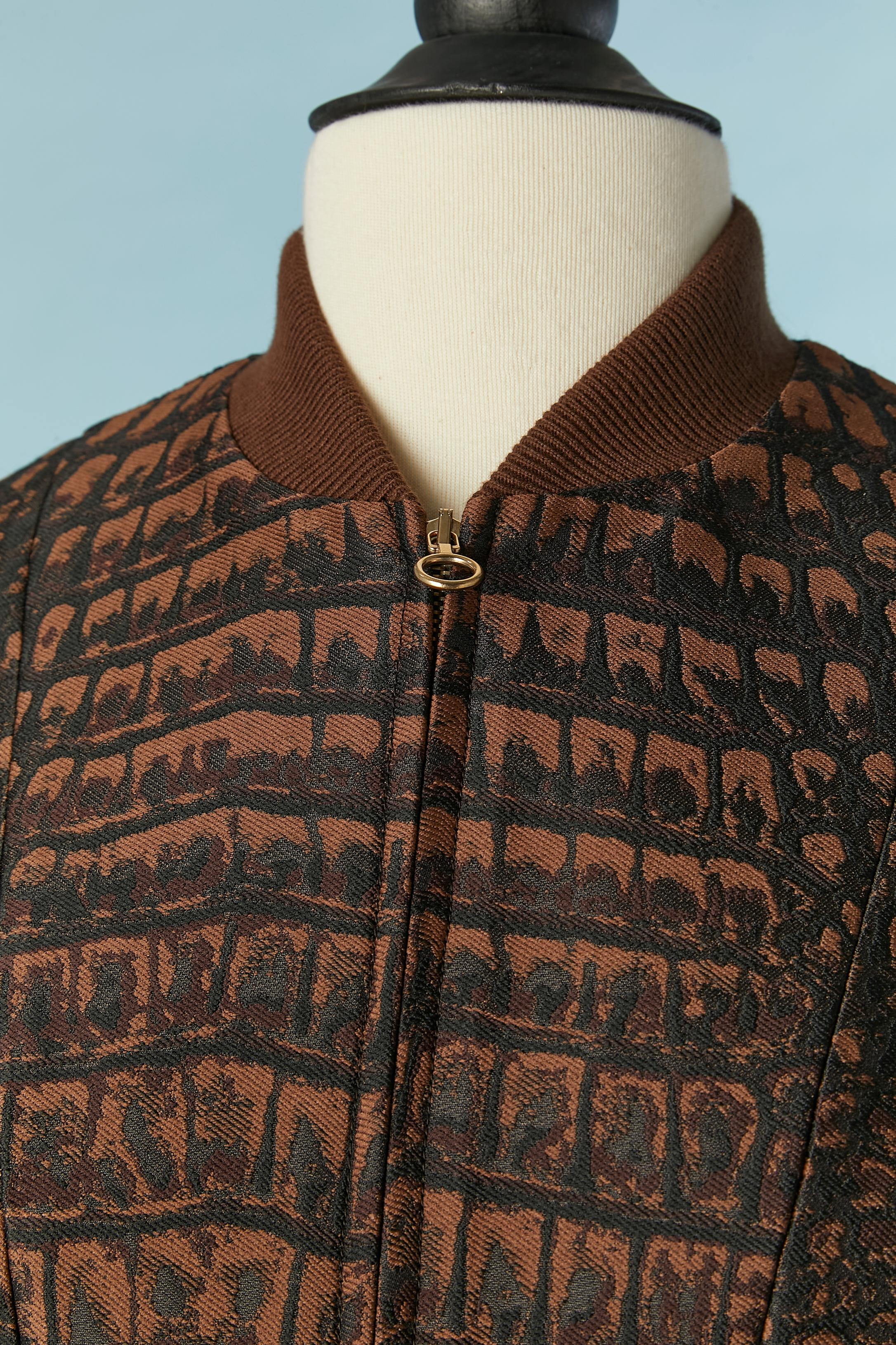 Completo di 3 pezzi (cappotto, bustier e pantaloni) con motivo jacquard in coccodrillo marrone e nero. Composizione del tessuto: 84% poliestere, 16% seta. Non c'è fodera, ma tubature. 
Chiusura con zip al centro del cappotto e tasche su entrambi i