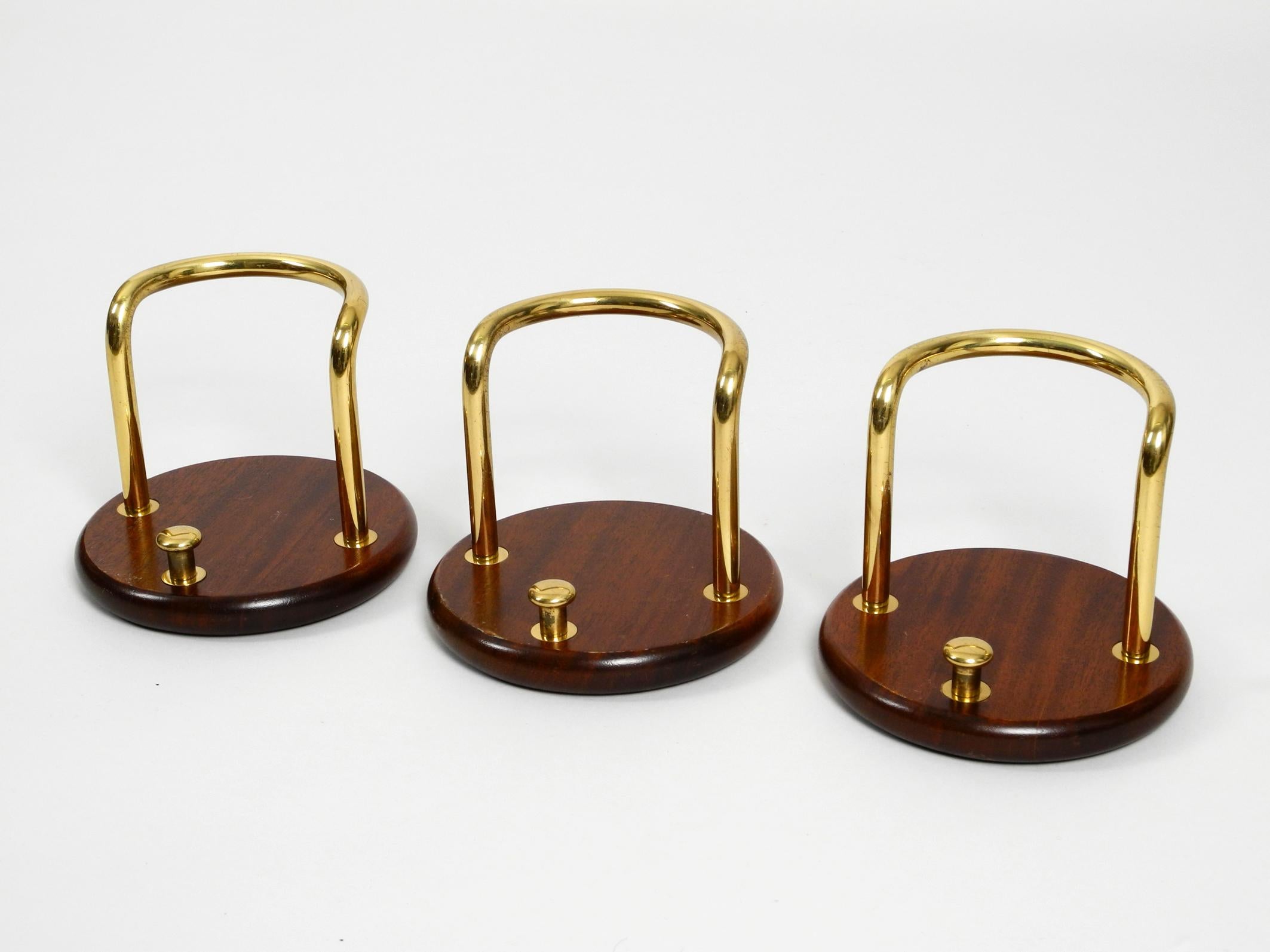 3 pieces very elegant large wall hooks from the 1970s.
Very elegant high-quality design with beautiful patina.
Solid teak base with a small and large brass hook. 
With two screws each will be mounted to the wall 
Very decorative and suitable for