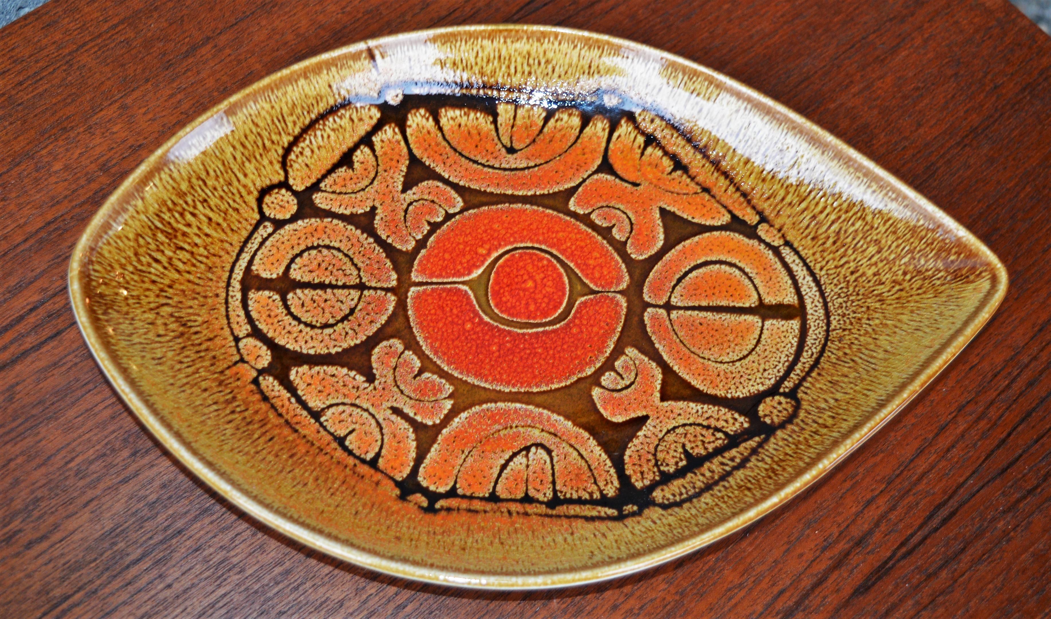 This delightful set of three Poole pottery dishes have wonderful abstract designs in oranges, golds and browns and a distinctive leaf shape. From the Aegean series, 1970s, and in excellent condition with minor crazing to the glaze typical for their