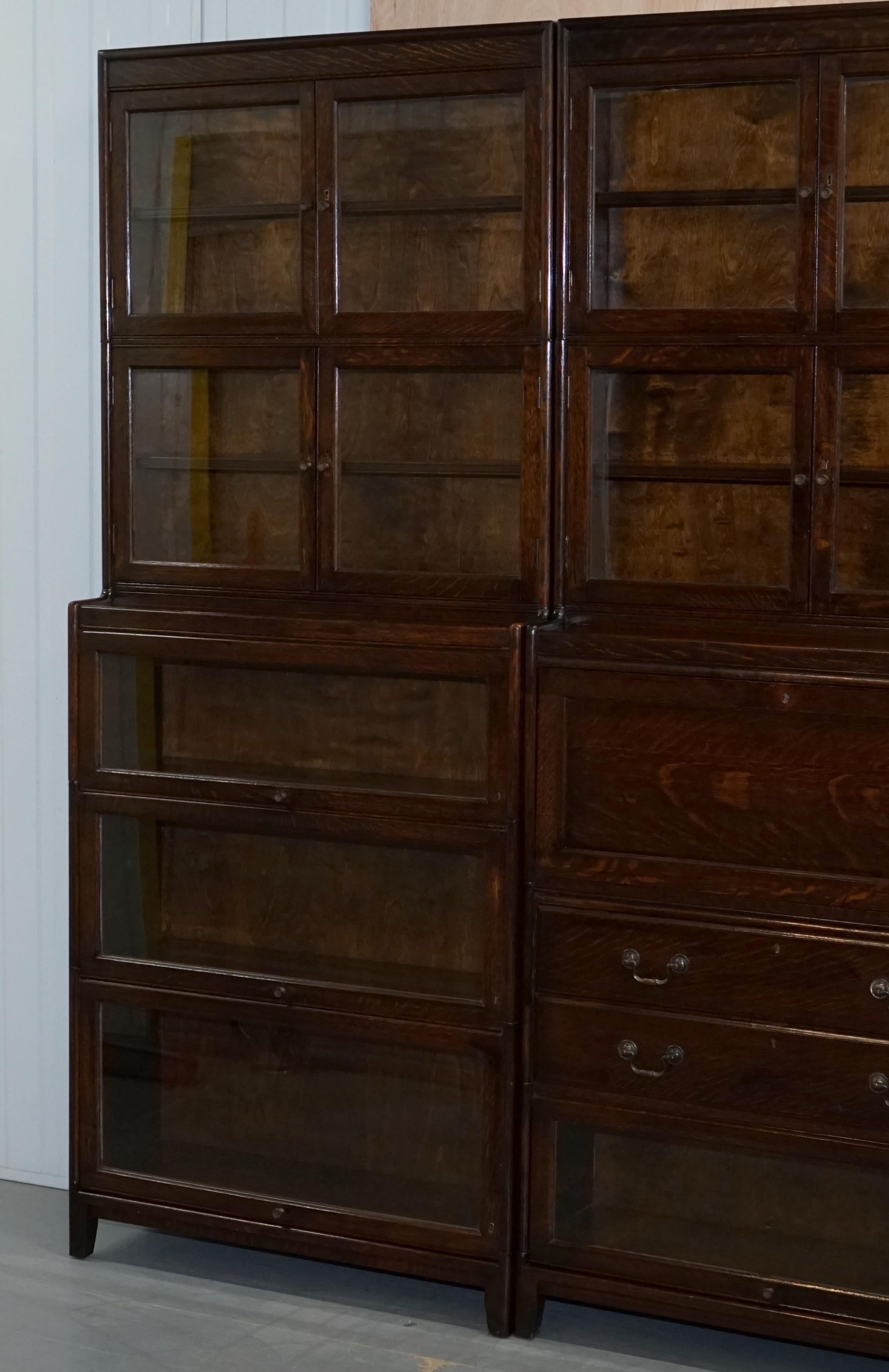 We are delighted to offer for sale this very rare circa 1920 suite of three Gunn solid oak stacking modular Library bookcases with rare drawer section and bureau desk piece

This is an exceptionally rare find, firstly if you are not familiar with