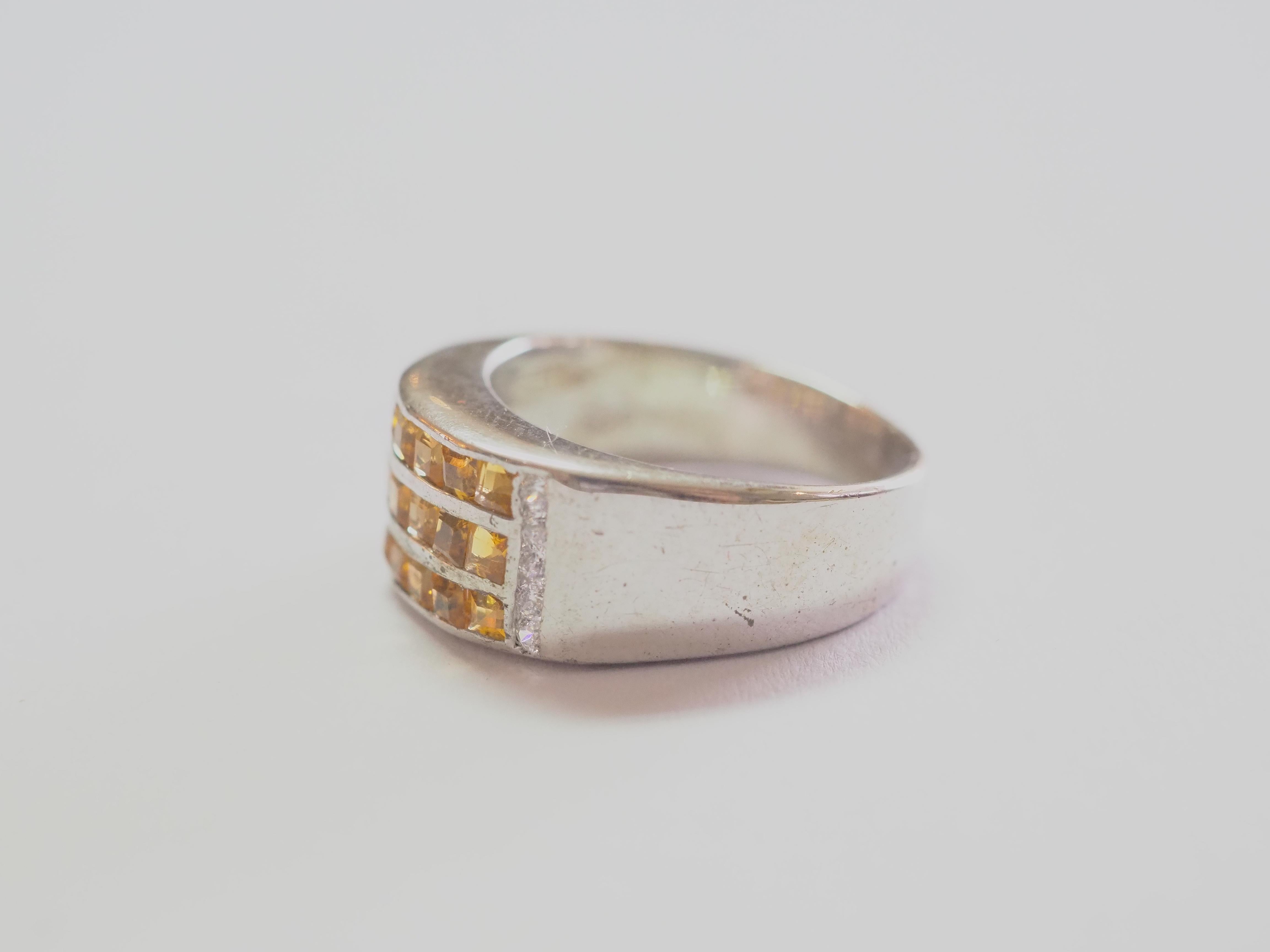 Opportunity starting at only 50!

This ring is a beautiful wide band ring in solid sterling silver. The ring is decorated by natural squared yellow citrine masterfully channeled into 3 lines. The vibrant citrine gemstone is one of the most popular