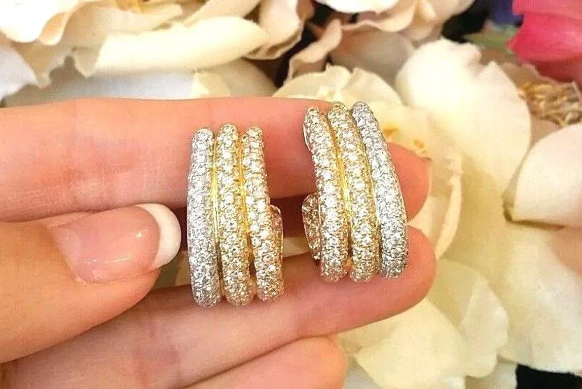 Three Row Diamond Pavè Half Hoop Earrings 5.42 carats total weight in 18k Gold

Three Row Diamond Pavè Half Hoop Earrings feature 187 Round Brilliant Cut Diamonds pavè set in 18k White, Yellow, and Rose Gold. The earrings are secured by Omega clip