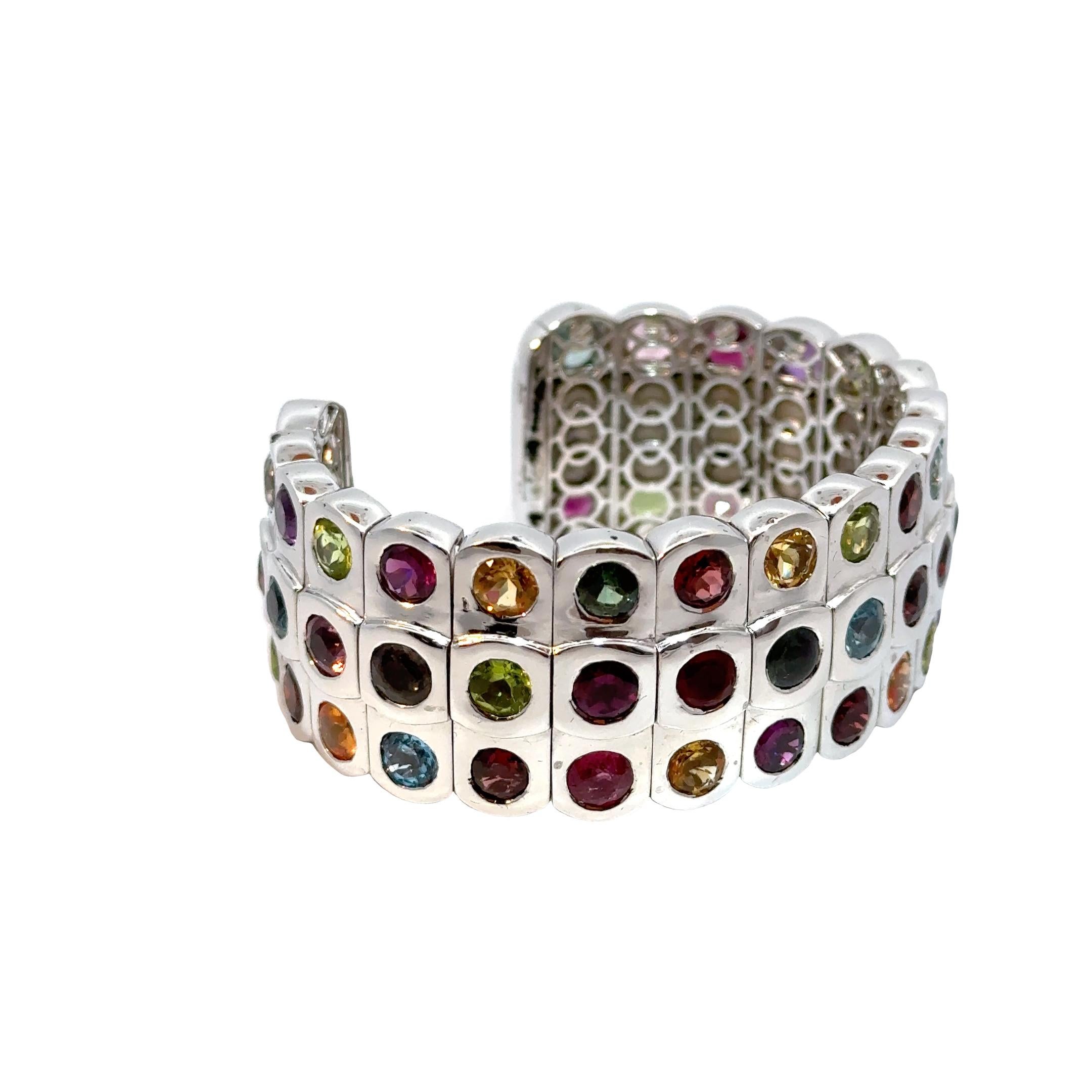 Ecco una descrizione del prodotto di 122 parole per il braccialetto di pietre preziose:

Questo bracciale con gemme arcobaleno è un pezzo unico, apprezzato per il suo design artistico e per i suoi colori vivaci. Realizzato in lussuoso oro bianco 18