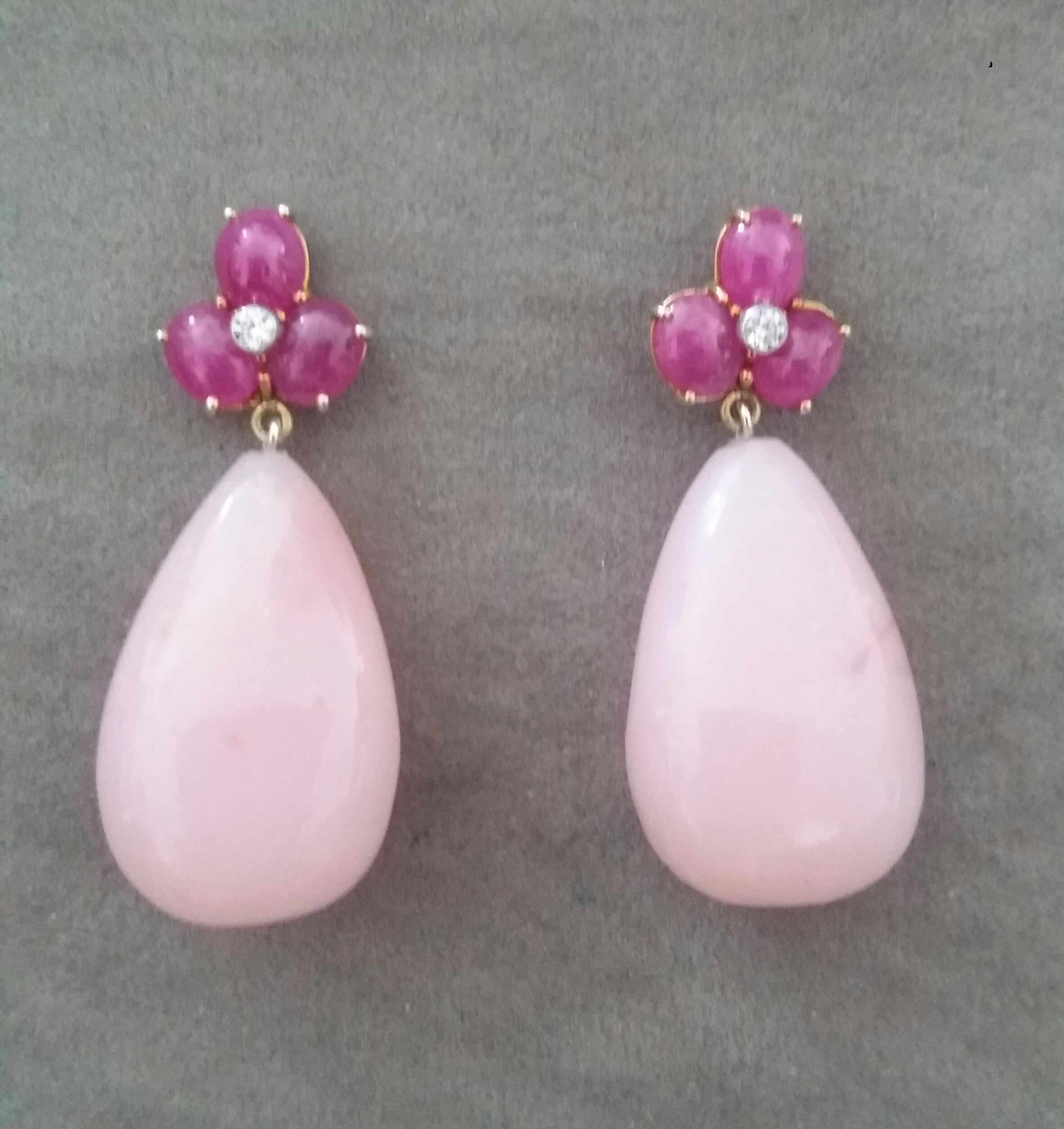 Elegant and completely handmade Earrings consisting of an upper part of 3 oval shape Ruby cabs of 4 mm x 5 mm set together in 14 Kt yellow gold with 2 small diamonds in the center, at the bottom 2 nice big size Pear Shape Natural Pink Opals 