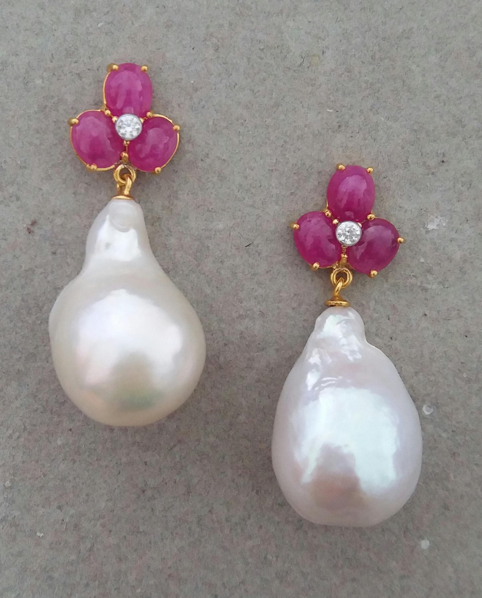 Elegant and completely handmade Earrings consisting of an upper part of 3 oval shape Ruby cabs of 4 mm x 5 mm set together in 14 Kt yellow gold with 2 small diamonds in the center, at the bottom 2 nice big size white color and high luster Pear Shape