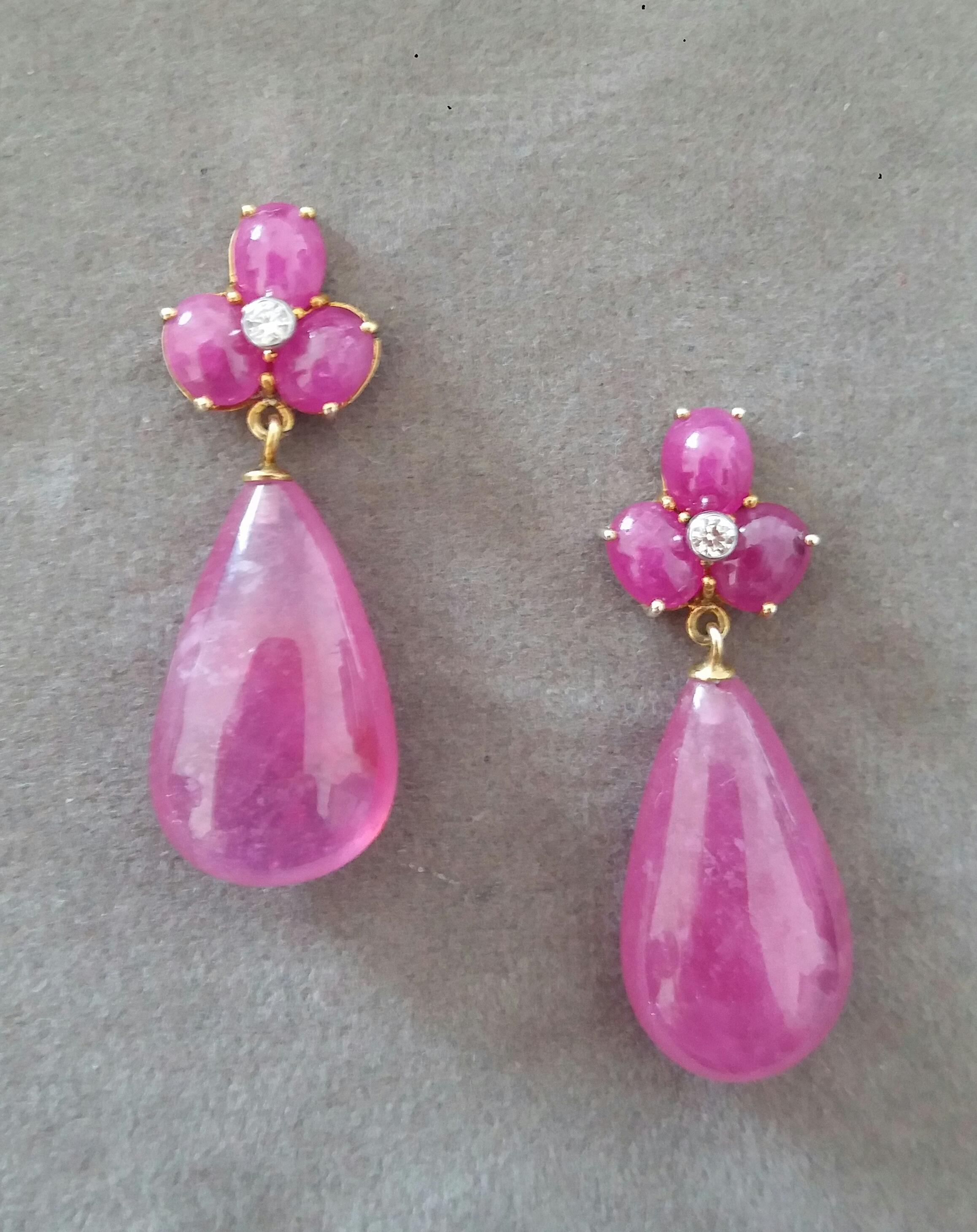 Elegant and completely handmade Earrings consisting of an upper part of 3 oval shape Ruby cabs of 4 mm x 5 mm set together in 14 Kt yellow gold with 2 small diamonds in the center, at the bottom 2 nice big size Pear Shape Natural Rubies measuring 13