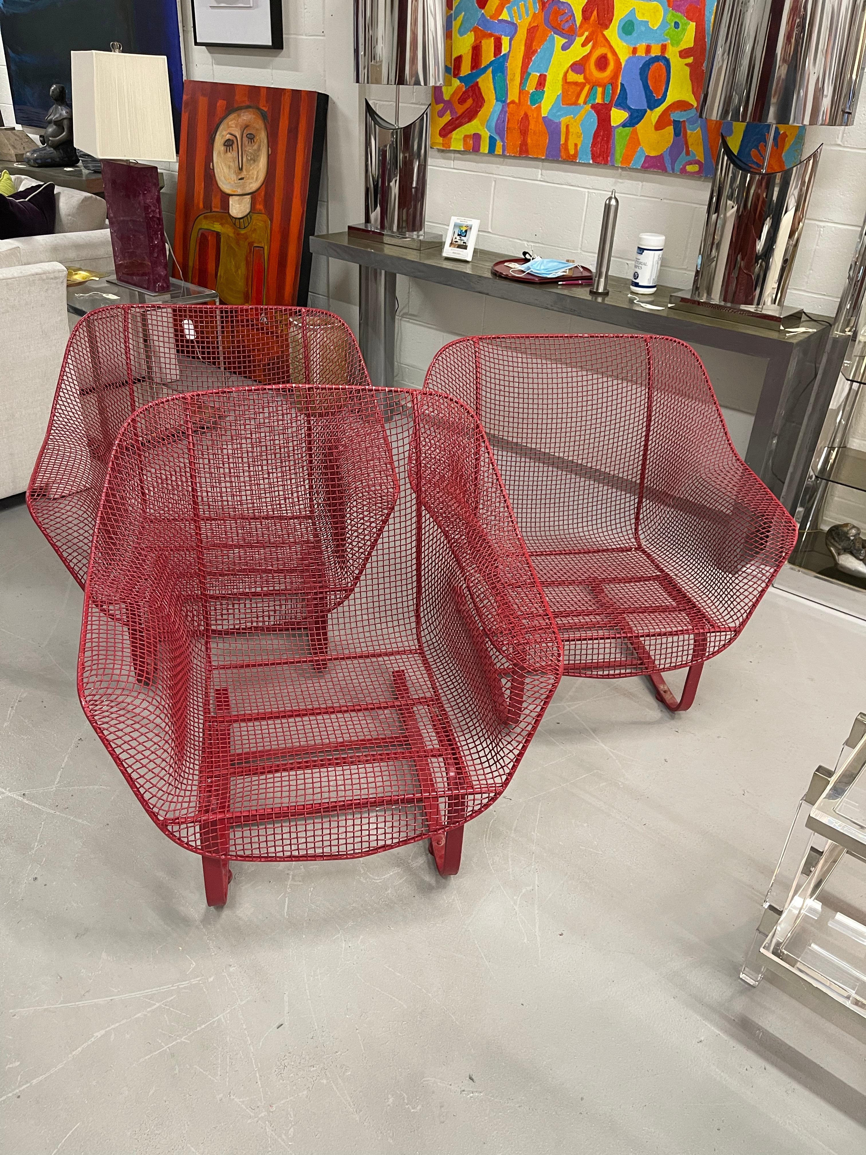 Hard to find grouping of three red painted Russell Woodard Sculptura Lounge chairs. Good condition with no breaks. Some minor paint loss. No pad inserts.