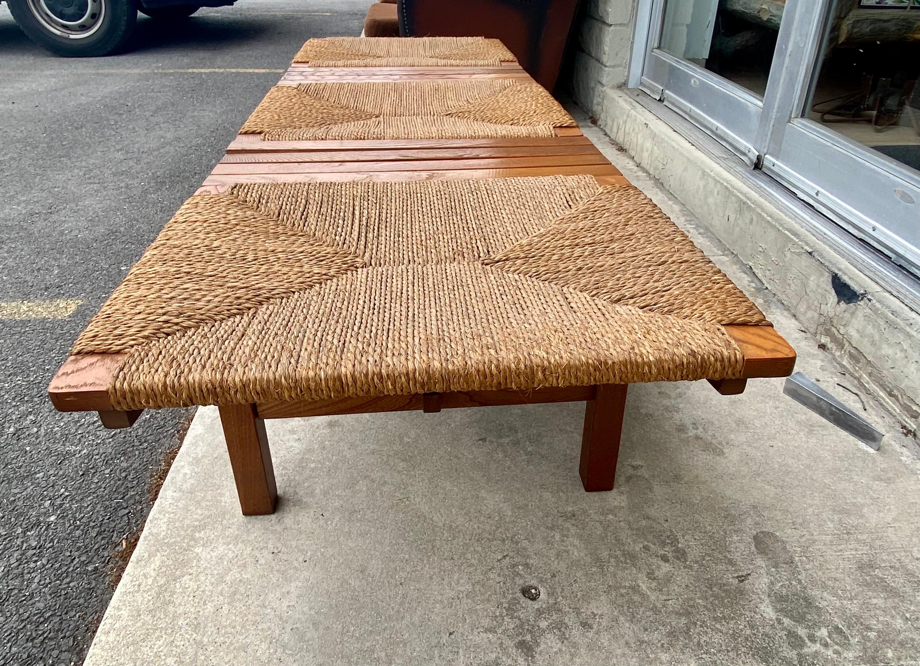Beautiful minimalist AFM Quality Furniture Japanese modernist 3-seat slat bench with a rush seat is made of walnut, circa 1960s, Japan. Similar to Scandinavian modern design, Japanese design has the same clean lines that are simple, understated, and