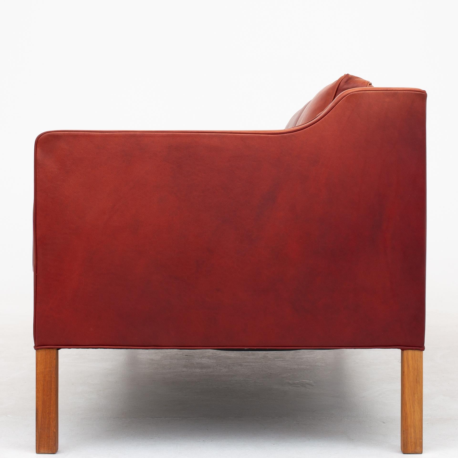 BM 2213, 3-seat sofa in original, patinated leather with legs of teak. Maker Fredericia Furniture.
