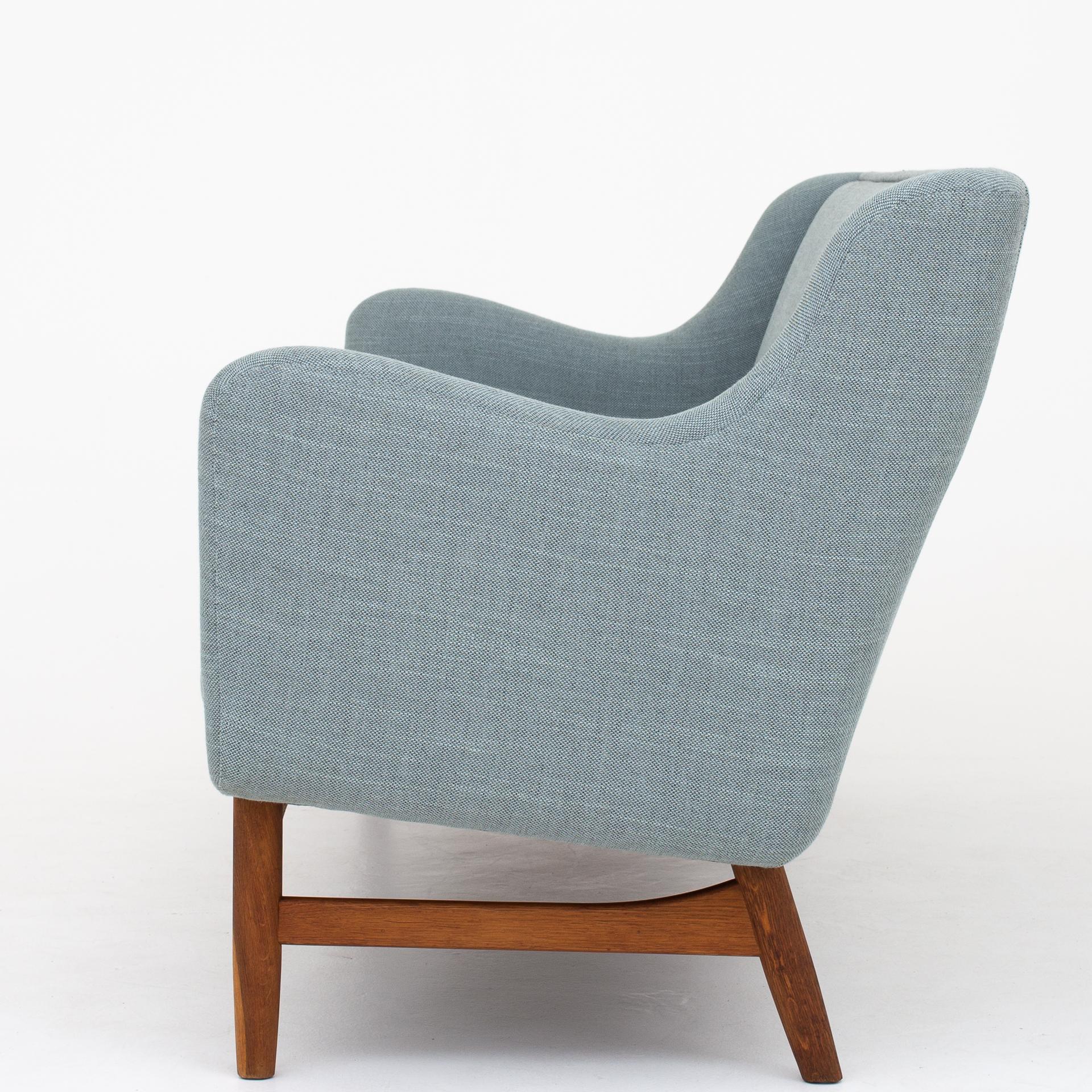 Reupholstered 3-seat sofa in Sunniva 2 (col. 152) with frame of patinated oak. Maker Søren Willadsen.