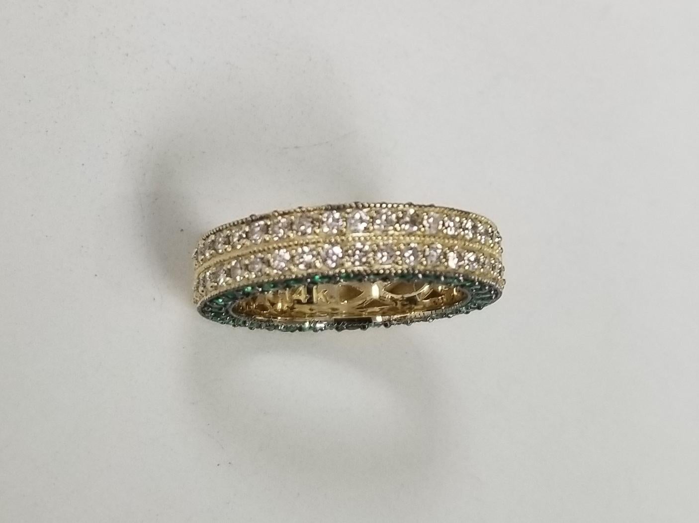 14k white gold ladies 2 row diamond pave eternity ring with diamond-cut emeralds (with black rhodium) pave in the side of the ring, containing 76 round full cut diamonds of very fine quality weighing 1.10cts. and 68 round emeralds weighing 1.20cts.