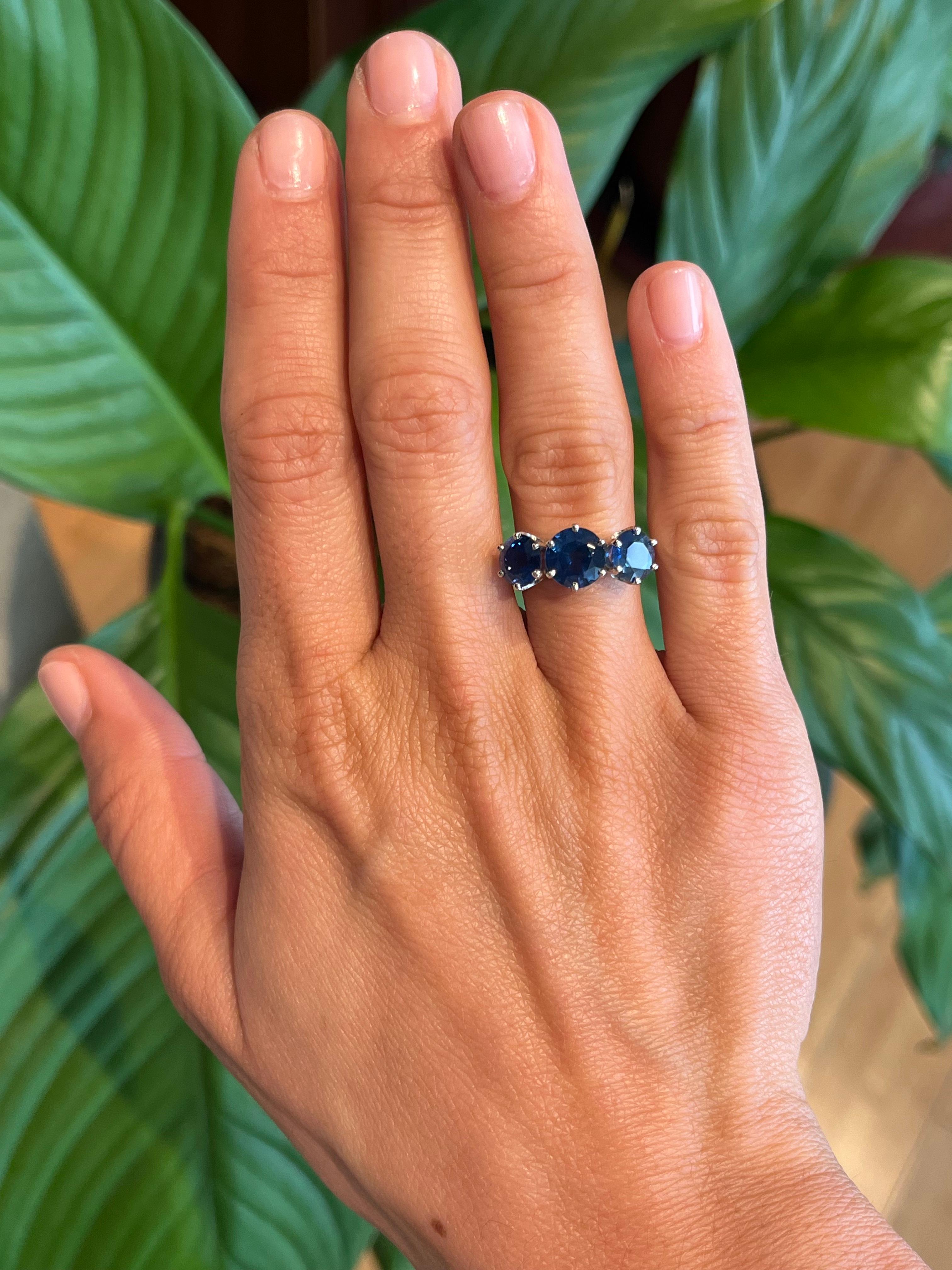 This exquisite 3-stone blue sapphire ring is a testament to refined craftsmanship. The 1.85ct center sapphire is flanked by two striking blue sapphires totaling 2.66cttw, all set in polished platinum. Pronged settings enhance the brilliance of each