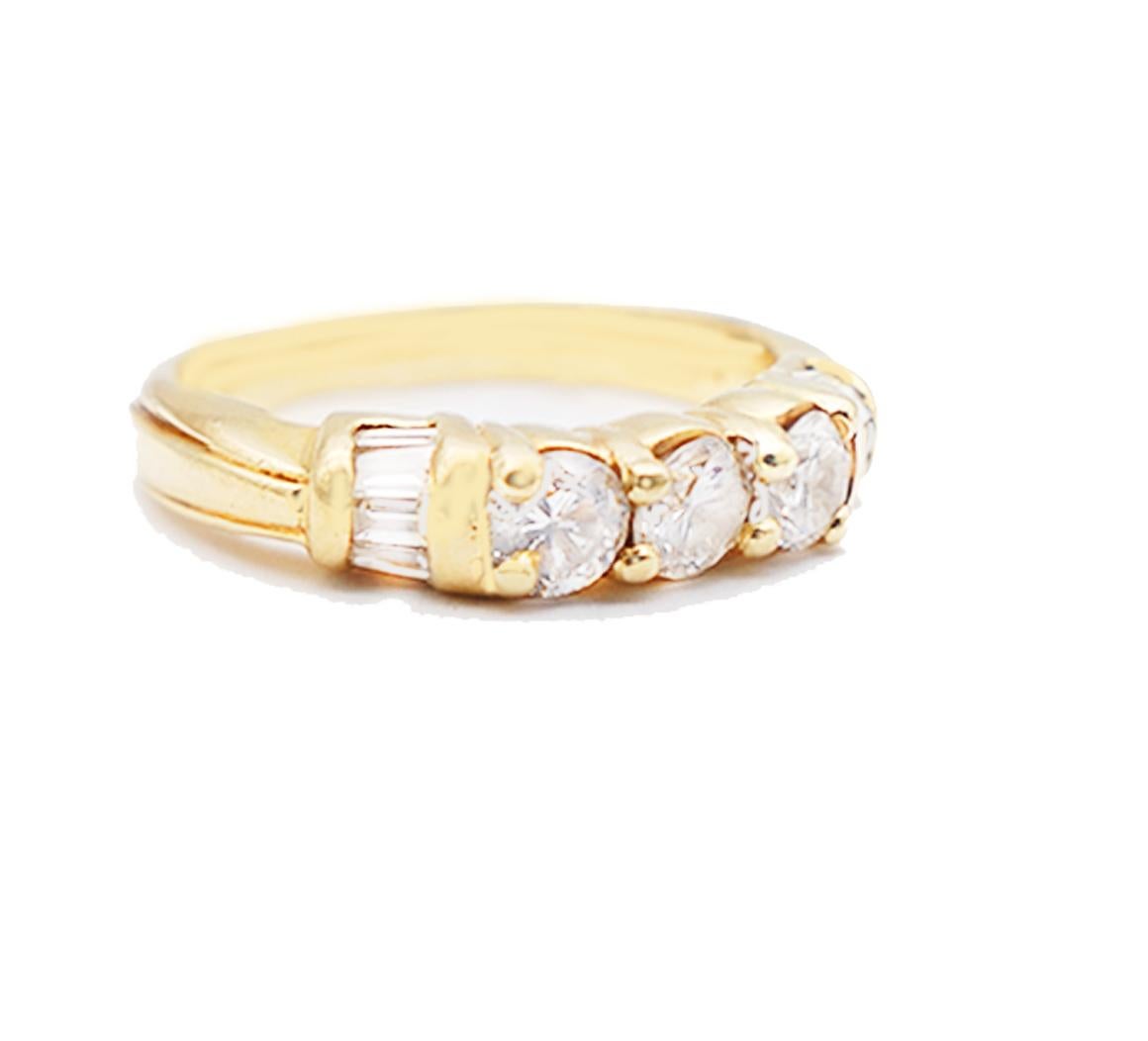 Traditional Engagement, Diamond Band set in 14 karat Yellow Gold.
3-stone diamonds are accented by baguettes on either sides. The center round diamonds are 4 mm. and have a total weight of .99 carat. 
On either side are  (10) baguette diamonds