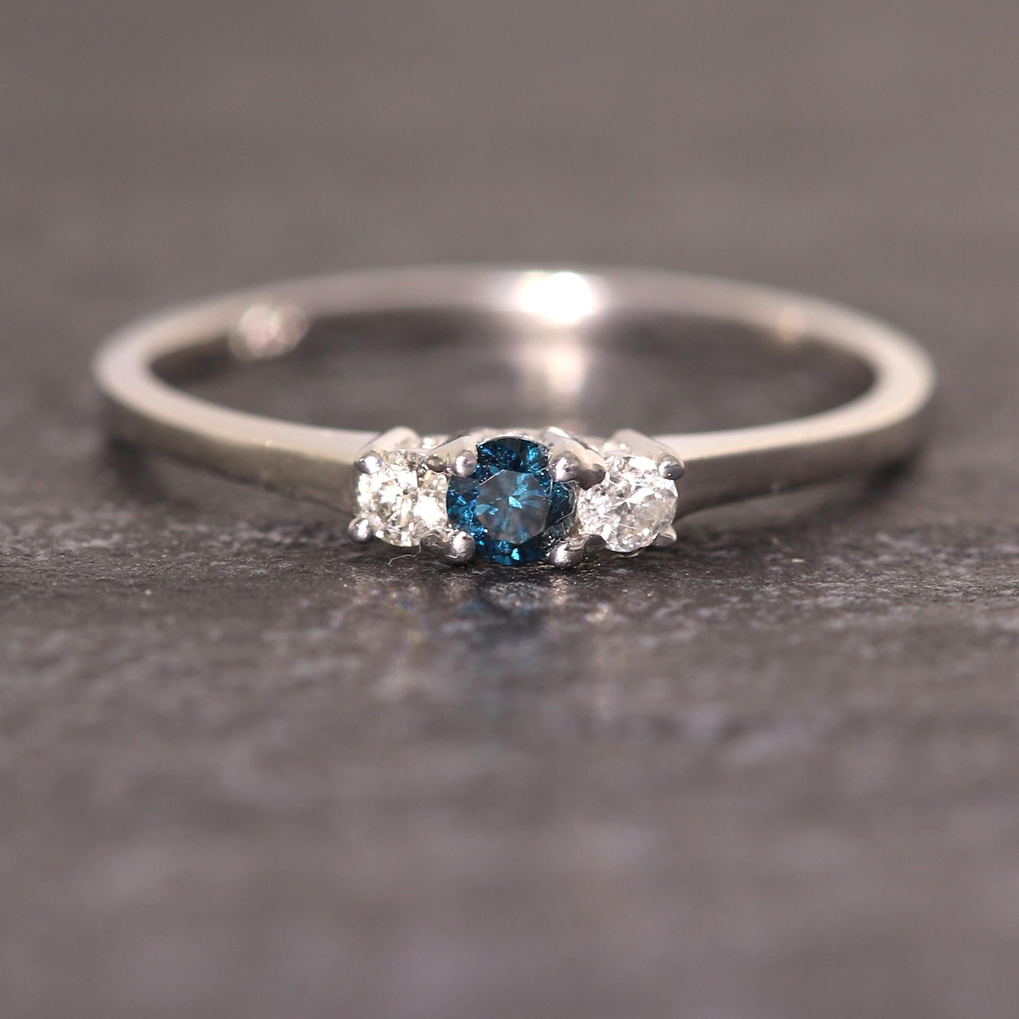 Anniversary 3 Stone Ring
14k White Gold 1.40 Grams
Natural Diamonds total 0.25 carat 
all stones are natural one blue diamond is treated blue and the other two are all natural GH-SI
Finger Size 7 
diamond sizes are 2mm and 3mm

Gift Box included