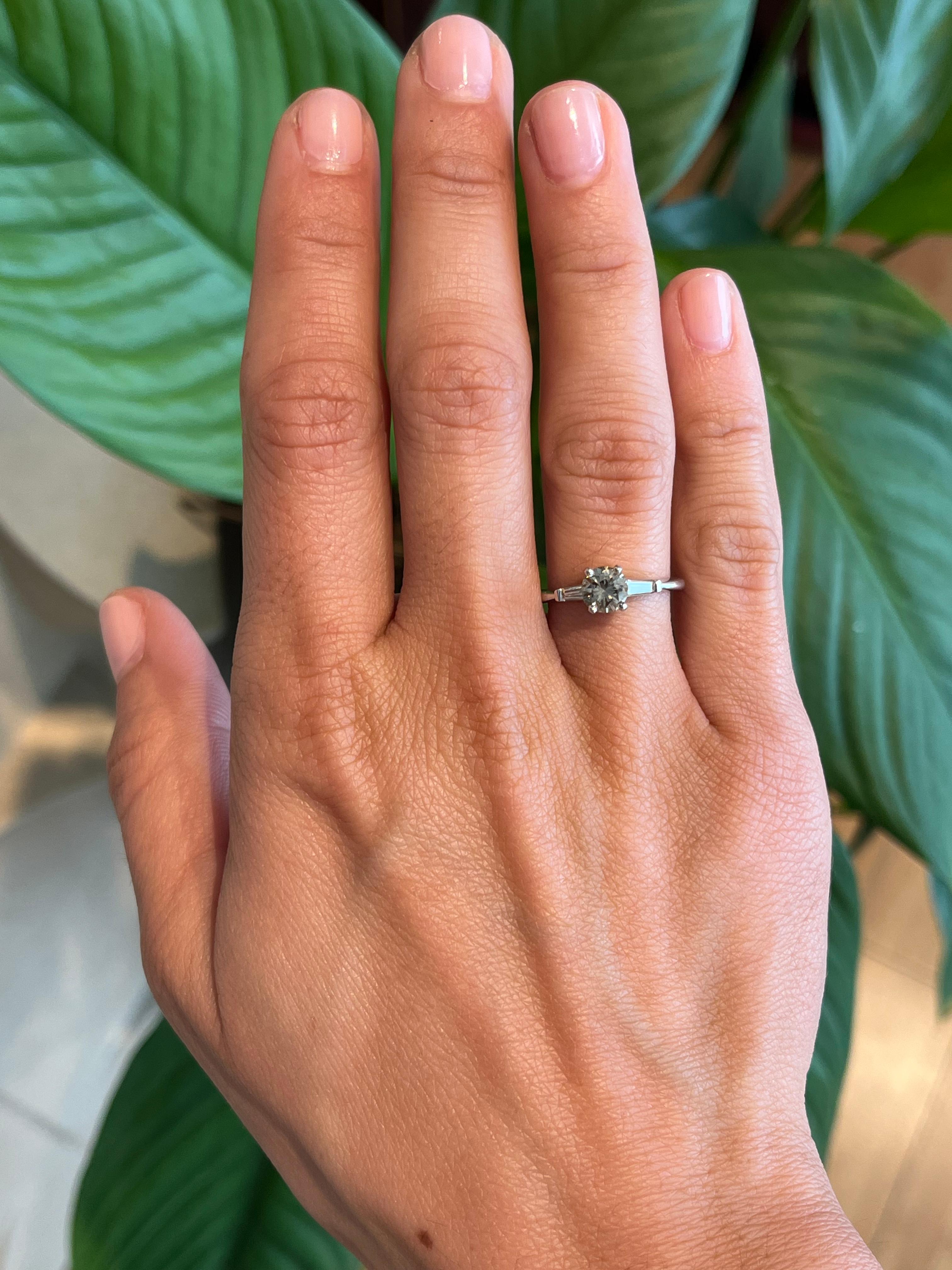 A refined yet bold take on the classic three-stone engagement ring, this design features a 0.60ct natural champagne diamond flanked by two baguette-cut diamonds. Set in polished 14K white gold, the contrast between warm and cool tones makes this