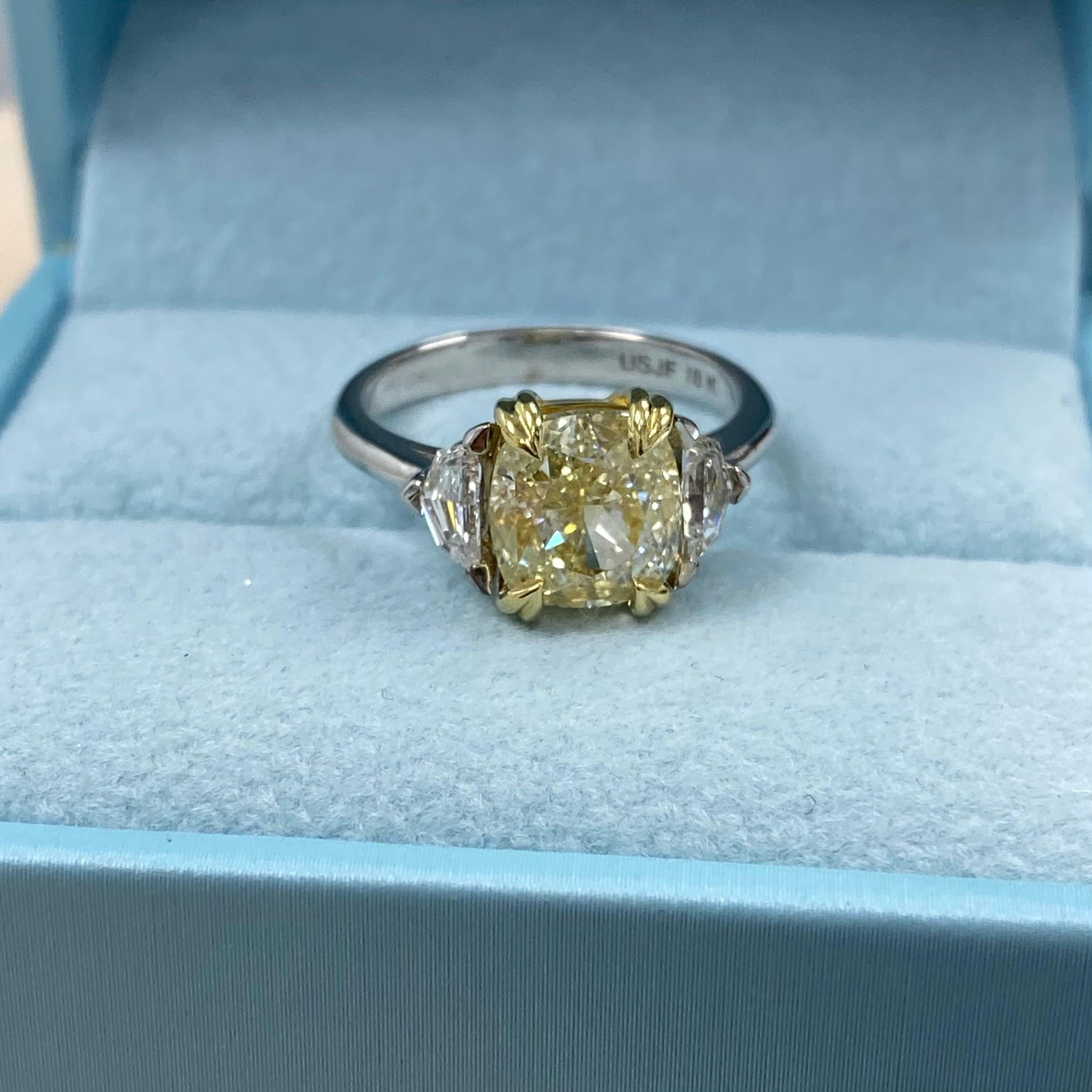This stunning design showcases a GIA-certified 3.14-carat cushion brilliant-cut light yellow diamond (W to X range) with exceptional VVS2 clarity as the centerpiece. The diamond measures 8.13 x 7.70 x 5.53 mm, radiating timeless elegance. GIA report