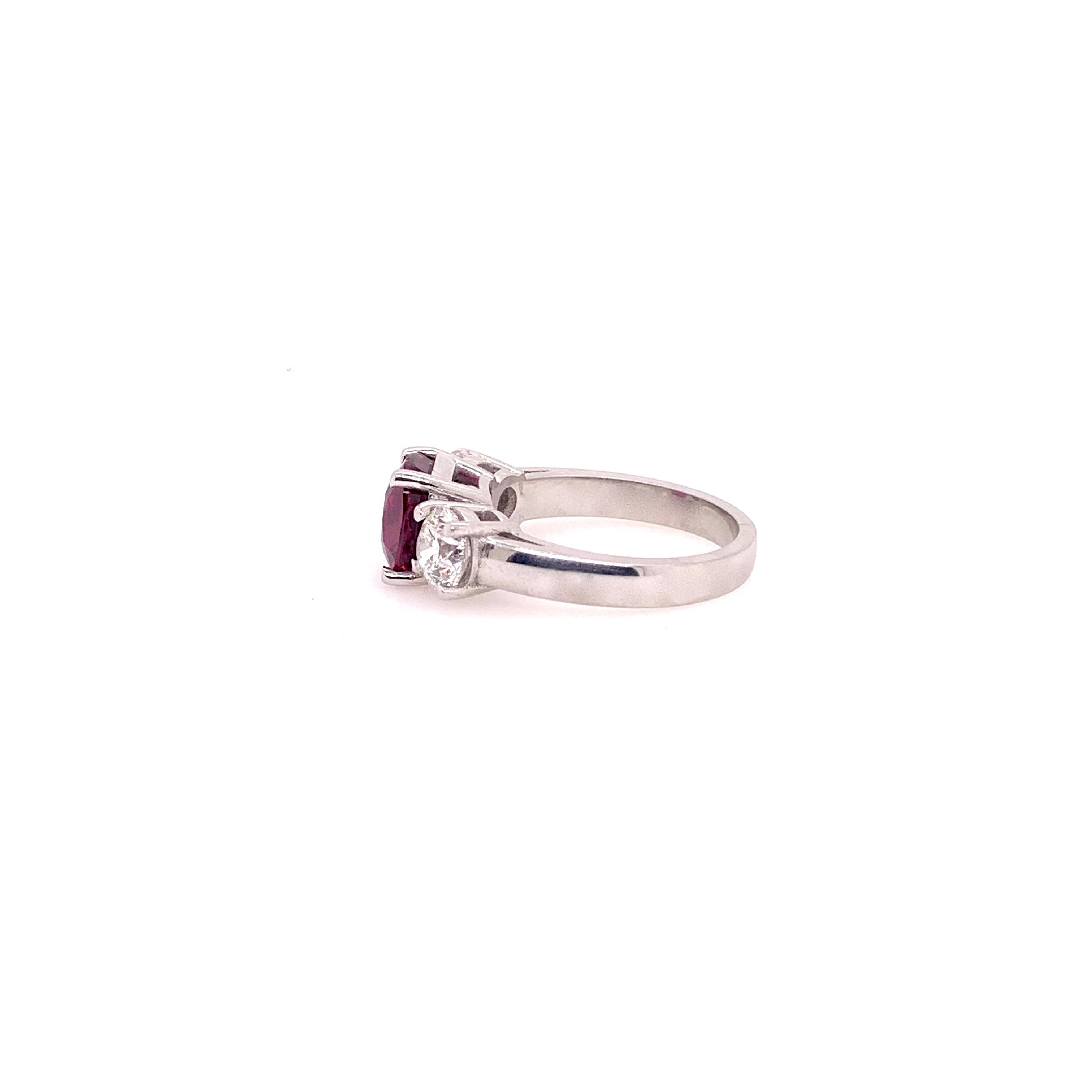 This handmade platinum setting showcases a stunning GIA certified, unheated cushion cut ruby that weighs 2.99 carats.  It is placed in between two GIA certified round brilliant diamonds, totaling 1.4 carats total weight with E color, VS2 clarity and