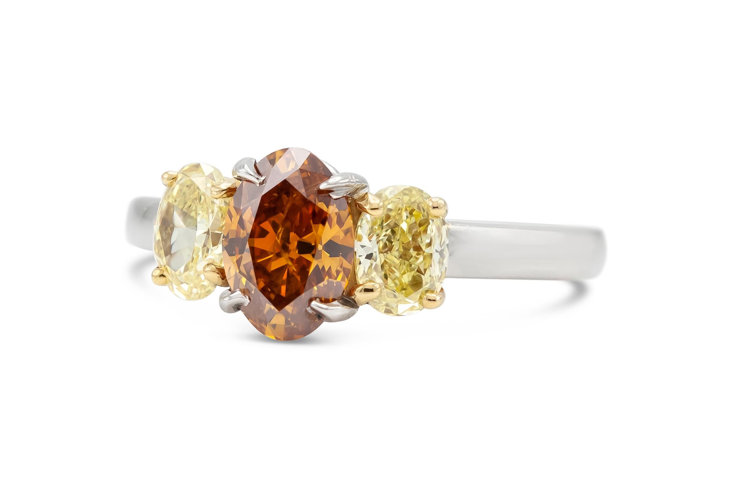Finely crafted in platinum with a center GIA certified 1.12 carat Fancy Deep Brownish Yellowish Orange diamond.
GIA certificate number: 2201779209
The ring features two yellow diamonds weighing approximately a total of 0.60 carats.