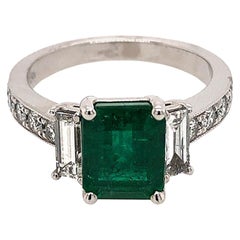 3-Stone Green Emerald Ring with Baguette Diamonds and Diamonds on the Shank 3-Stone Green Emerald Ring with Baguette Diamonds and Diamonds on the Shank