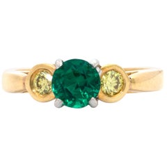 3-Stone Ring, with a Round Emerald Accentuated by 2 Fancy Yellow Diamonds