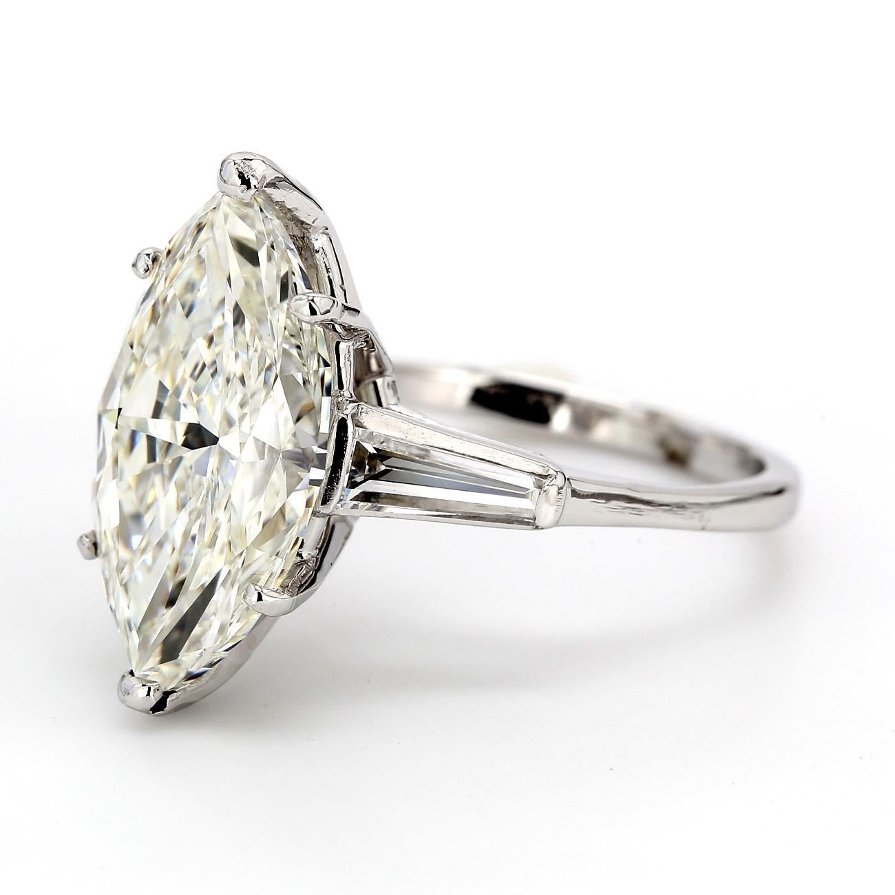 Three stone ring in platinum with GIA certified I/SI2 marquise center and channel set baguette diamond sides. D5.49ct.t.w. (Center - 5.48ct.)