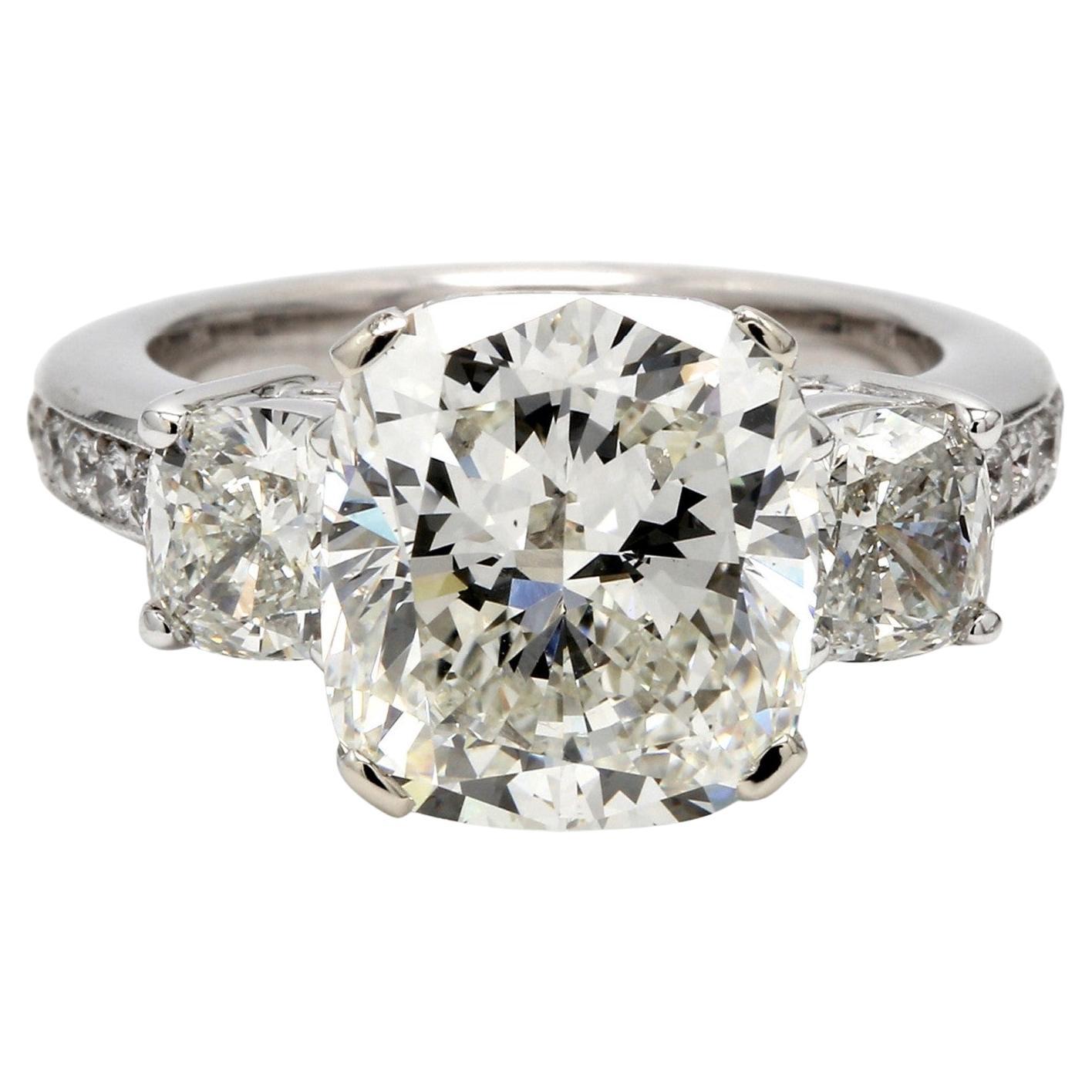 3-Stone Ring with J/SI2 GIA Cushion Cut Diamond Center & Cushion Sides. D8.19ct.