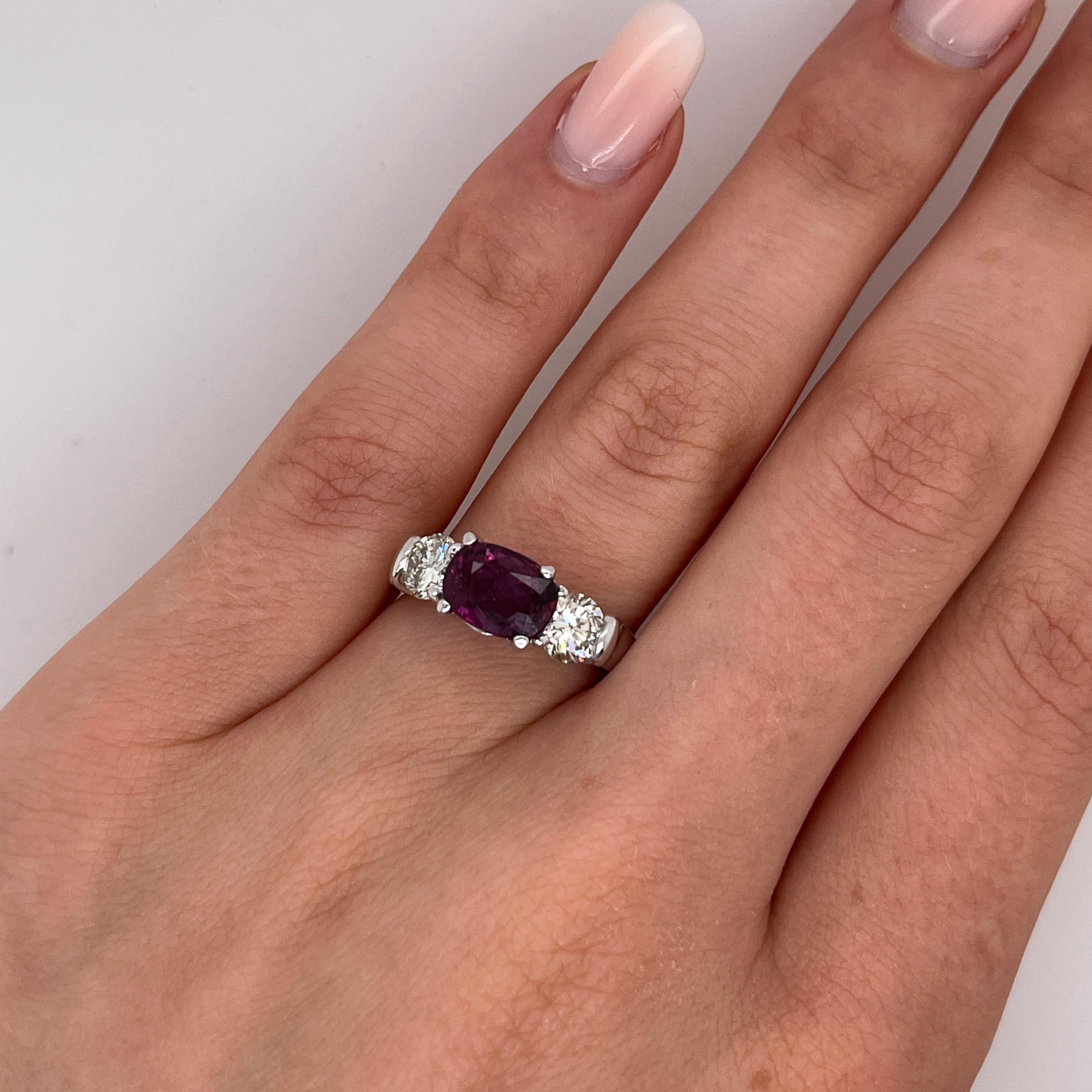 A stunning 14ct white gold ring set with an 1.97ct oval natural ruby at it's center, beautifully accented by 2 natural round diamonds, creating an elegant and timeless piece.

Total Diamond Weight: 1.0ct 
Diamond Colour: I
Diamond Clarity: