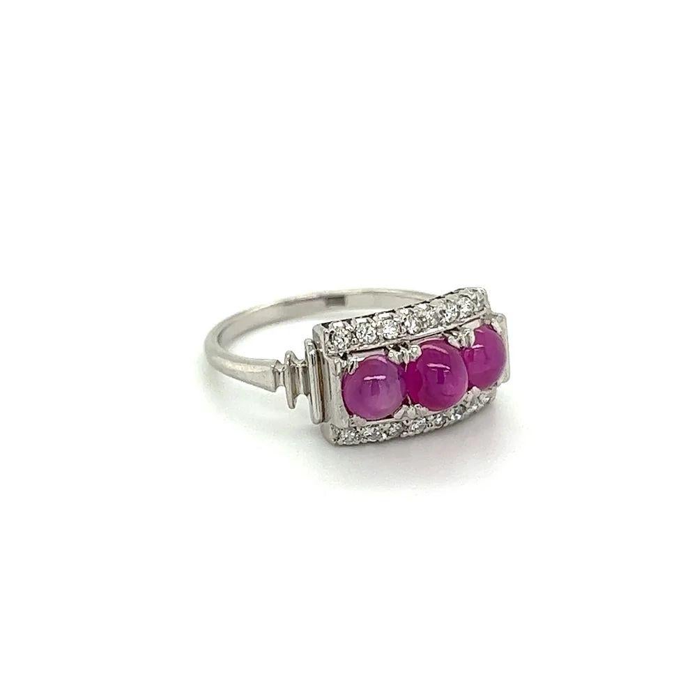 Simply Beautiful! Finely crafted Three Stone Star Ruby and Diamond Band Platinum Ring. Securely Hand set with 3 Rubies weighing approx. 1.15tcw, enhanced with Diamonds, weighing approx. 0.16tcw. Ring size: 5.5, we offer ring re-sizing. Dimensions