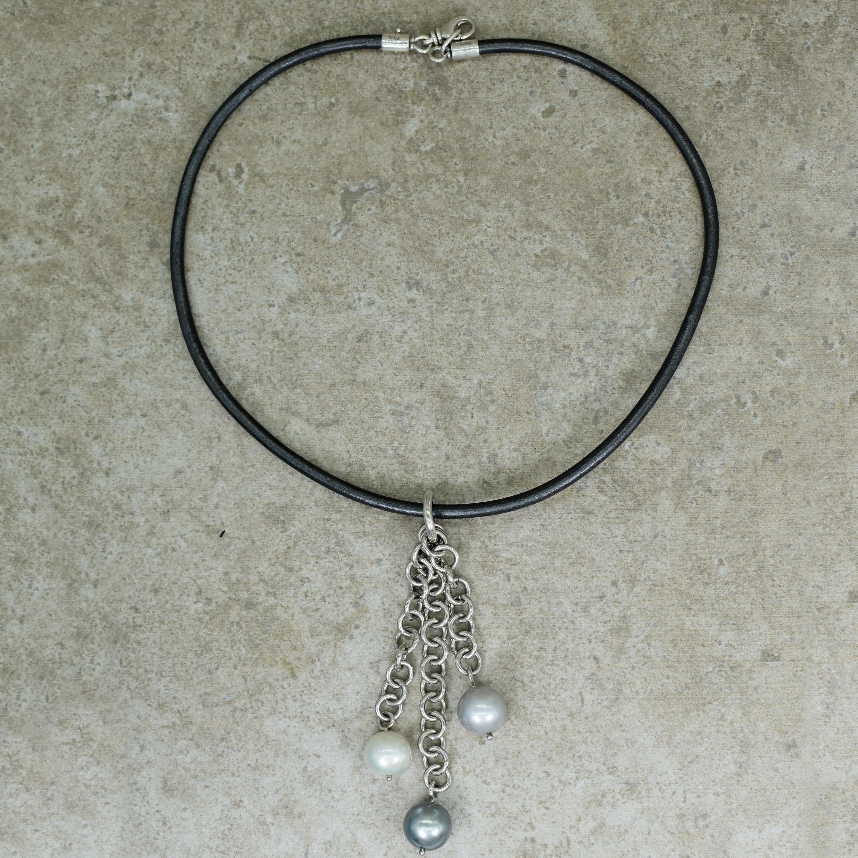 White, Gray and Tahitian Pearl 3-strand sterling silver chain dangle pendant on black leather cord necklace. Pearls are approximately 13mm in diameter. Leather necklace is 19 inches in length, and the longest chain Pearl drop in the pendant is 4.25